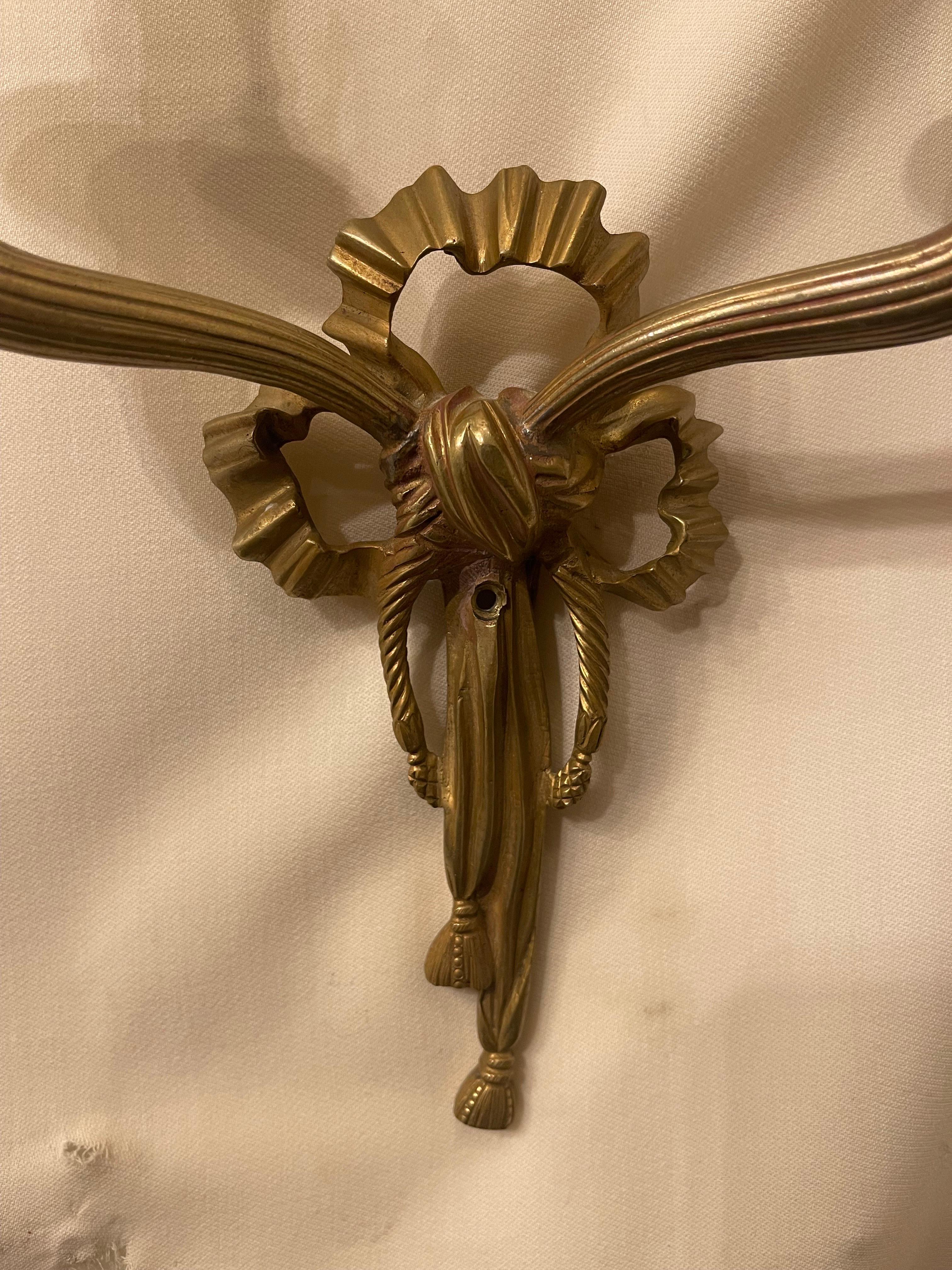 Wonderful Pair French Dore Bronze Caldwell Ribbon Tassel Wreath Two-Arm Sconces In Good Condition For Sale In Roslyn, NY