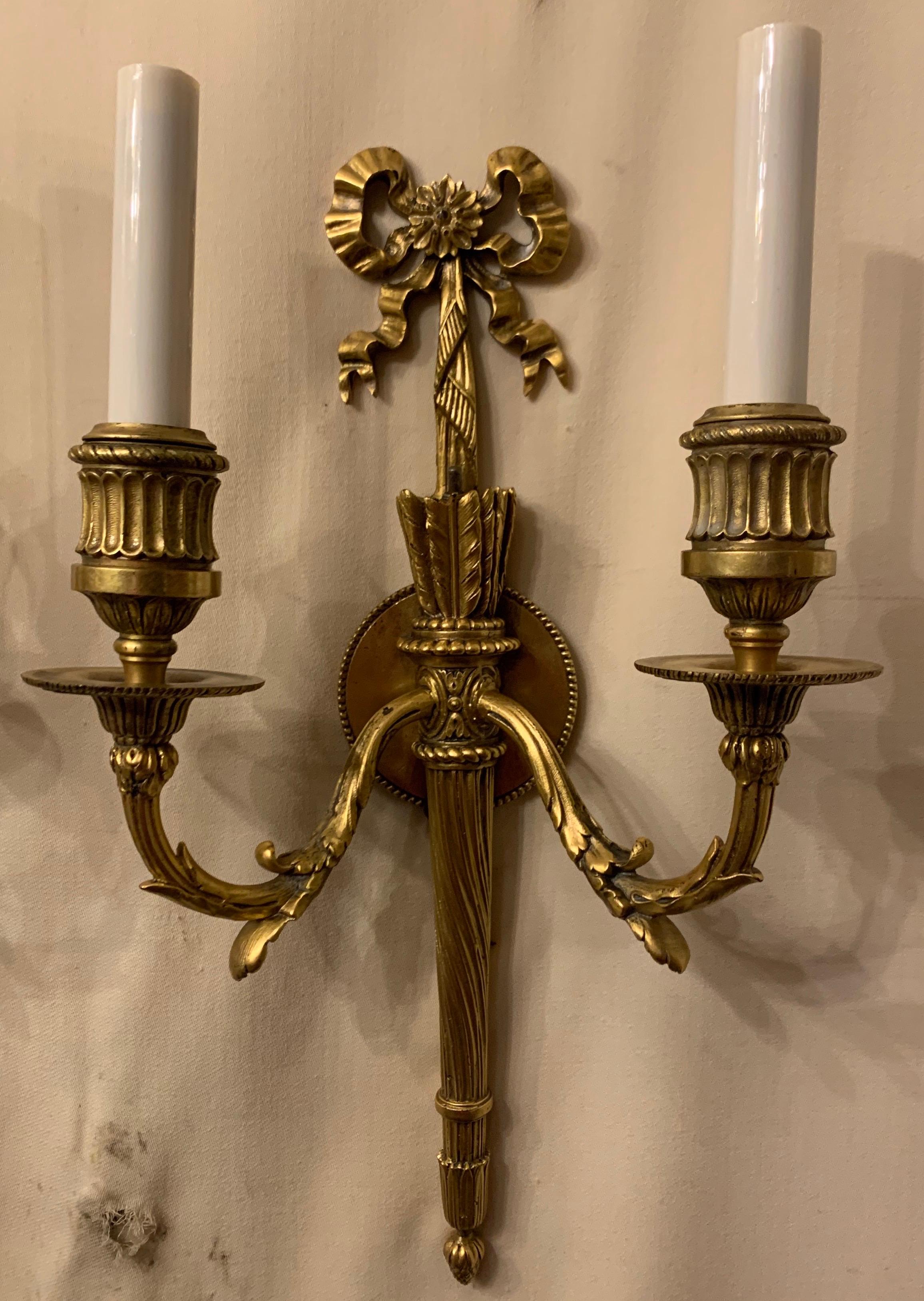 A wonderful pair of French gilt doré bronze bow top and back plate, torchiere two-light neoclassical sconces in the manner of E.F. Caldwell.
Completely rewired and ready to install and enjoy.
Approximate measurements:
15.5