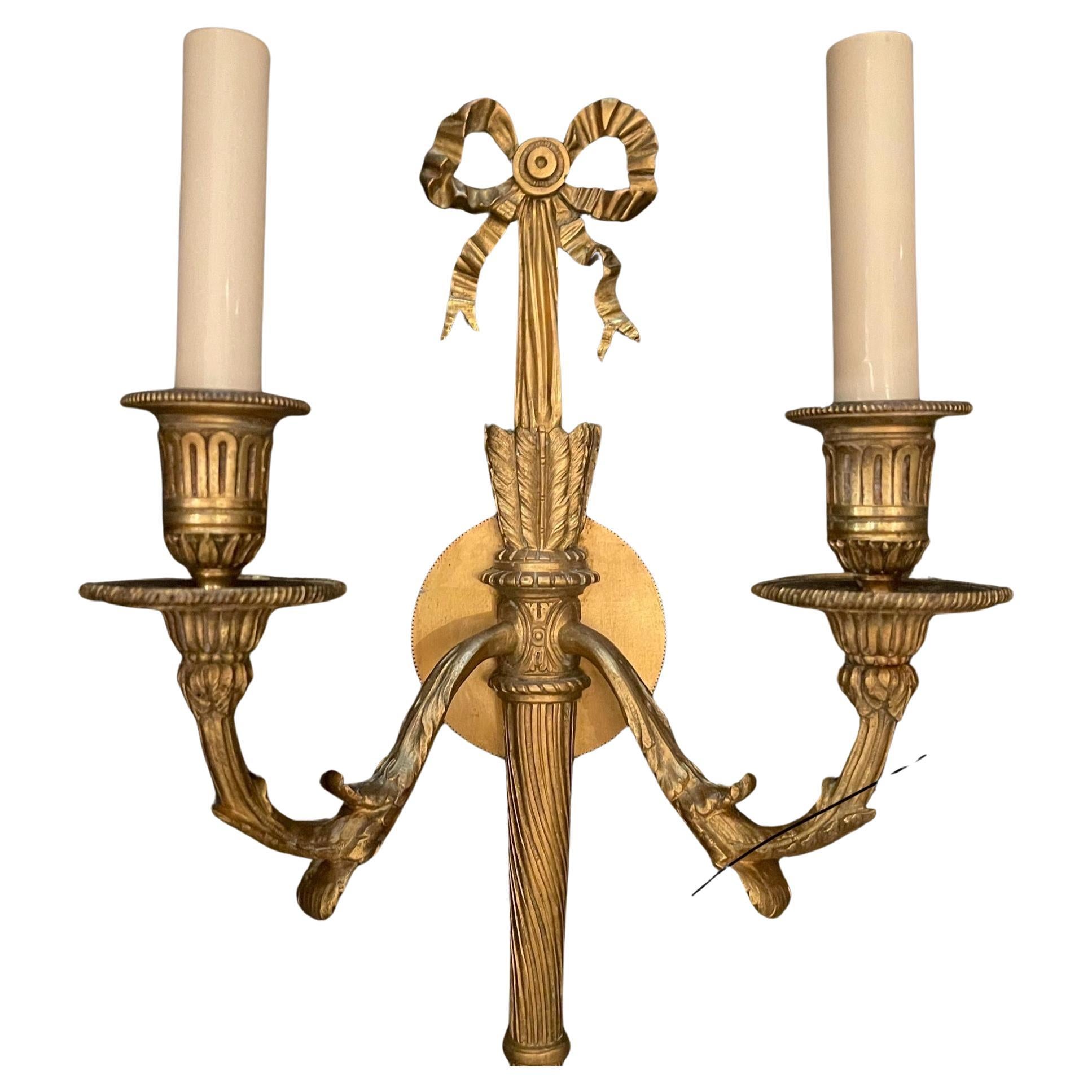 A wonderful pair of French gilt doré bronze bow top and back plate, torchiere two-light neoclassical sconces in the manner / style of E.F. Caldwell.
Completely rewired and ready to install and enjoy.
Approximate measurements:
15.5