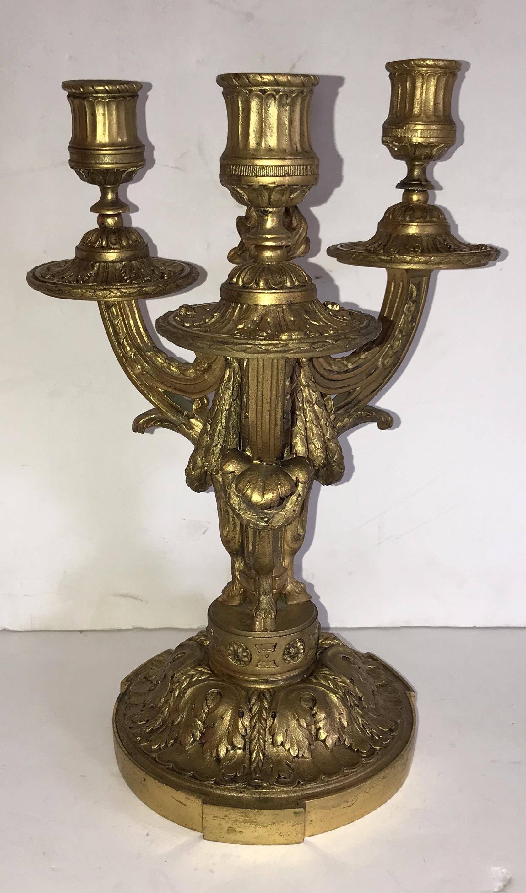 A wonderful pair of French gold gilt doré bronze neoclassical three-arm Candelabra in the manner of E.F. Caldwell, with very fine detail throughout.