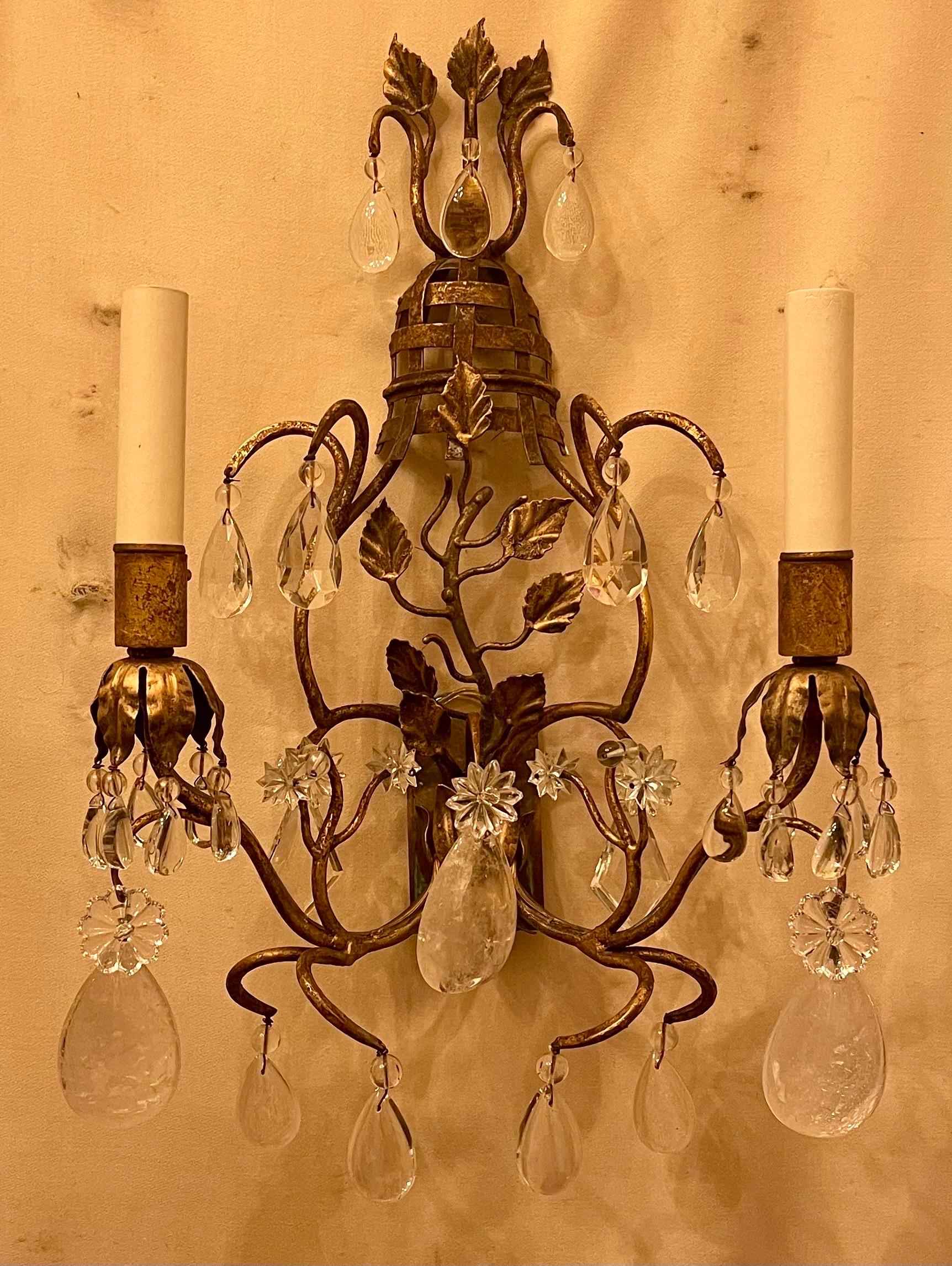 A wonderful pair of French Gold Gilt sconces with crystal & rock crystal drops in a basket bouquet form, in the manner of Maison Baguès.