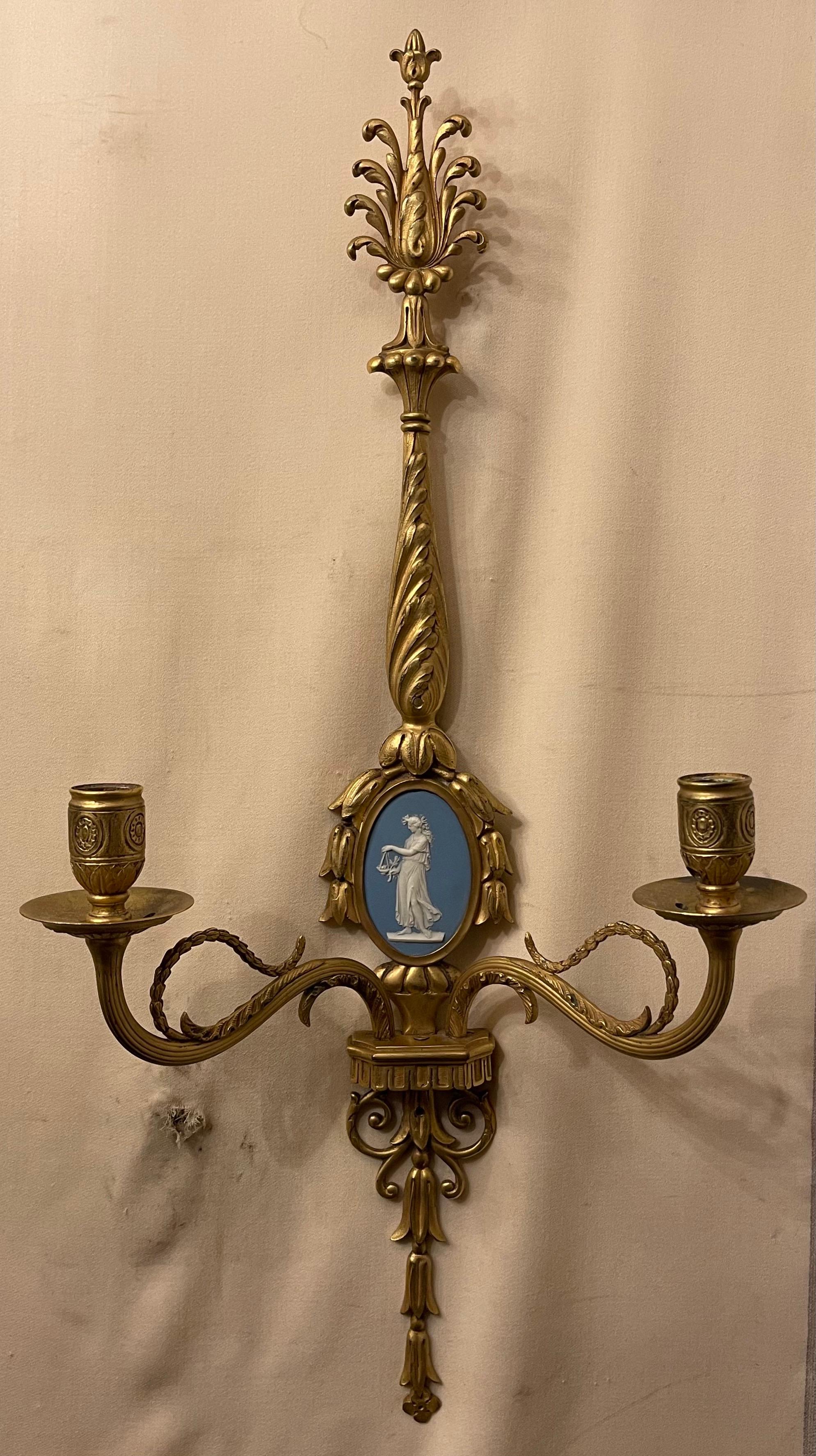 A wonderful pair of French Louis XVI style dore bronze & Wedgwood plaque two arm sconces in the manner of E. F. Caldwell.
Wiring is available at no additional charge.