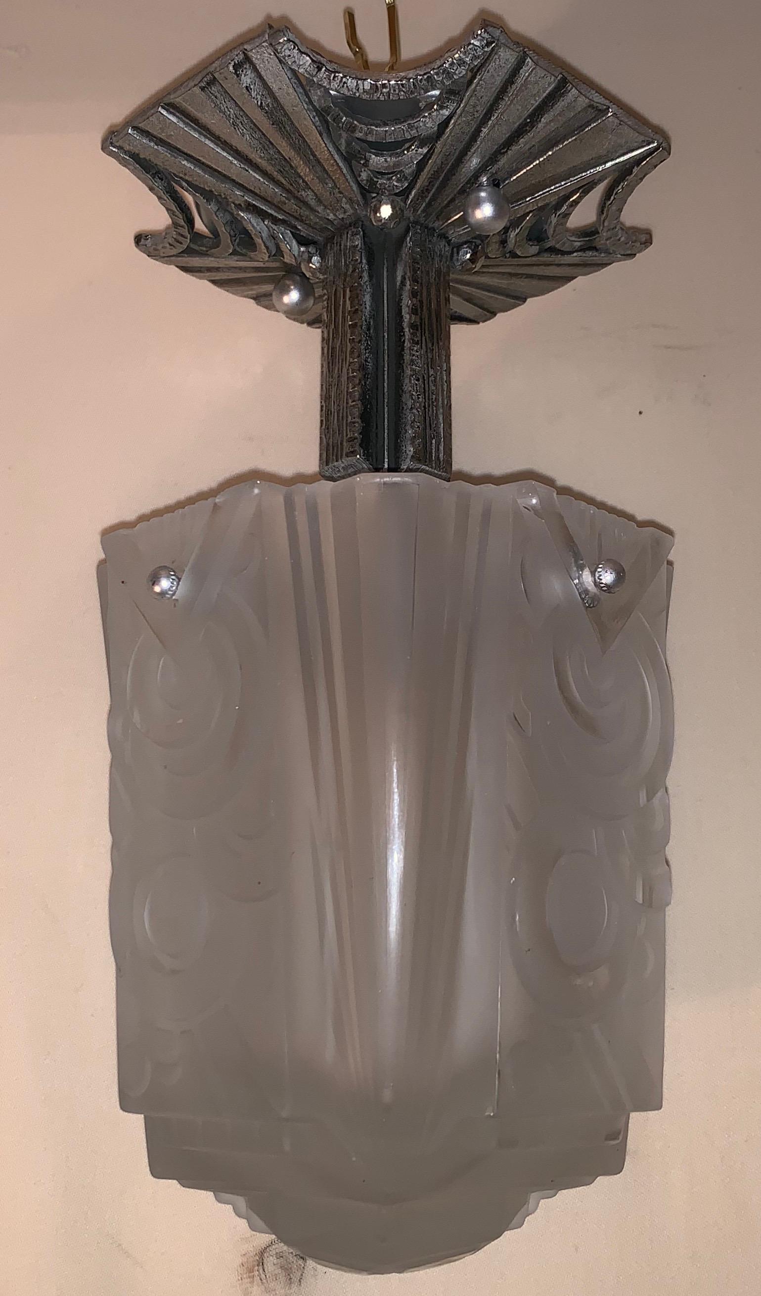 A wonderful French silvered bronze art deco & frost glass shade flush mount light fixture, with one candelabra light inside taking up to 60 watts. In the manner of Muller Frères.