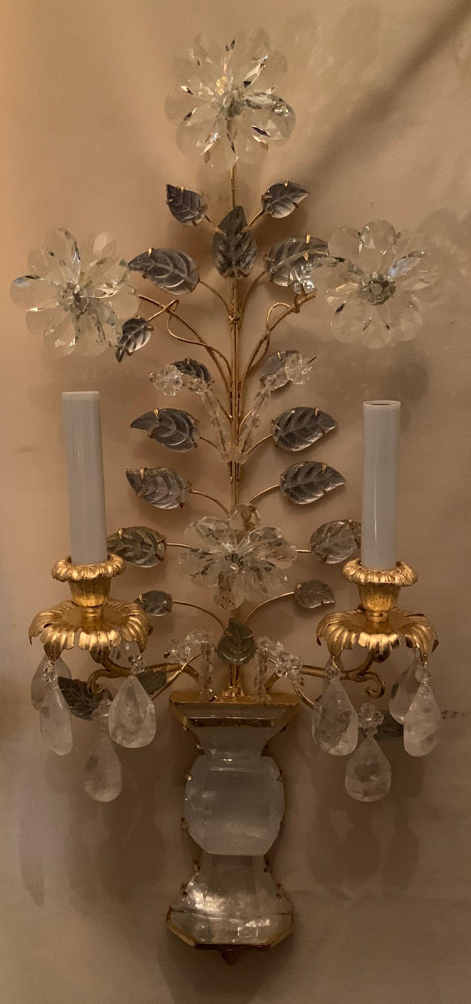 A wonderful pair of gold gilt and rock crystal Baguès style flower and leaf Mid-Century Modern 2 candelabra light wall sconces
completely rewired with new sockets and are ready to install and enjoy.

