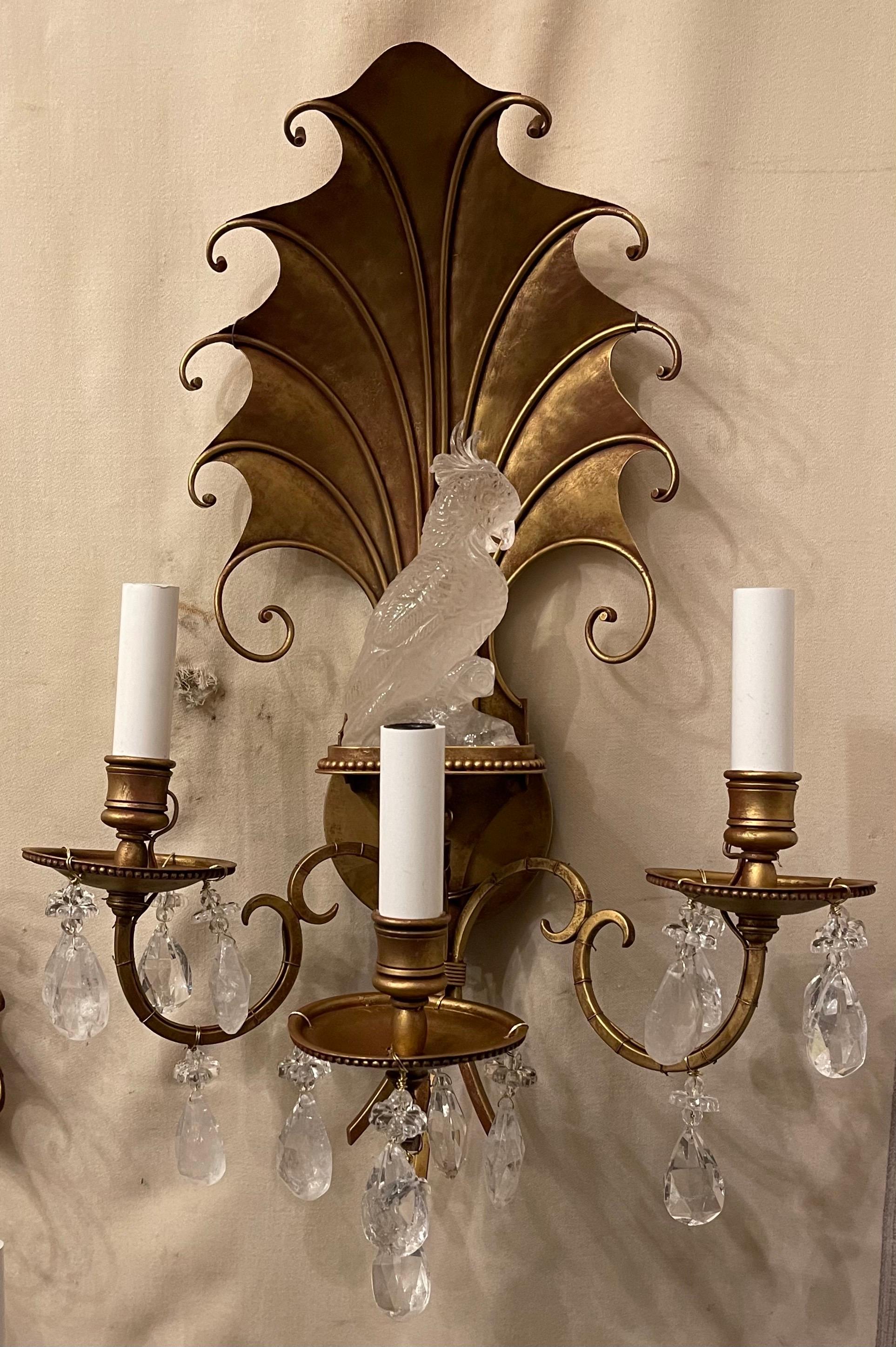 A wonderful vintage pair of gold gilt shell form and rock crystal cockatoo bird sconces in the manner of Maison Baguès each with three candelabra sockets that have been completely rewired and come with mounting hardware for installation.