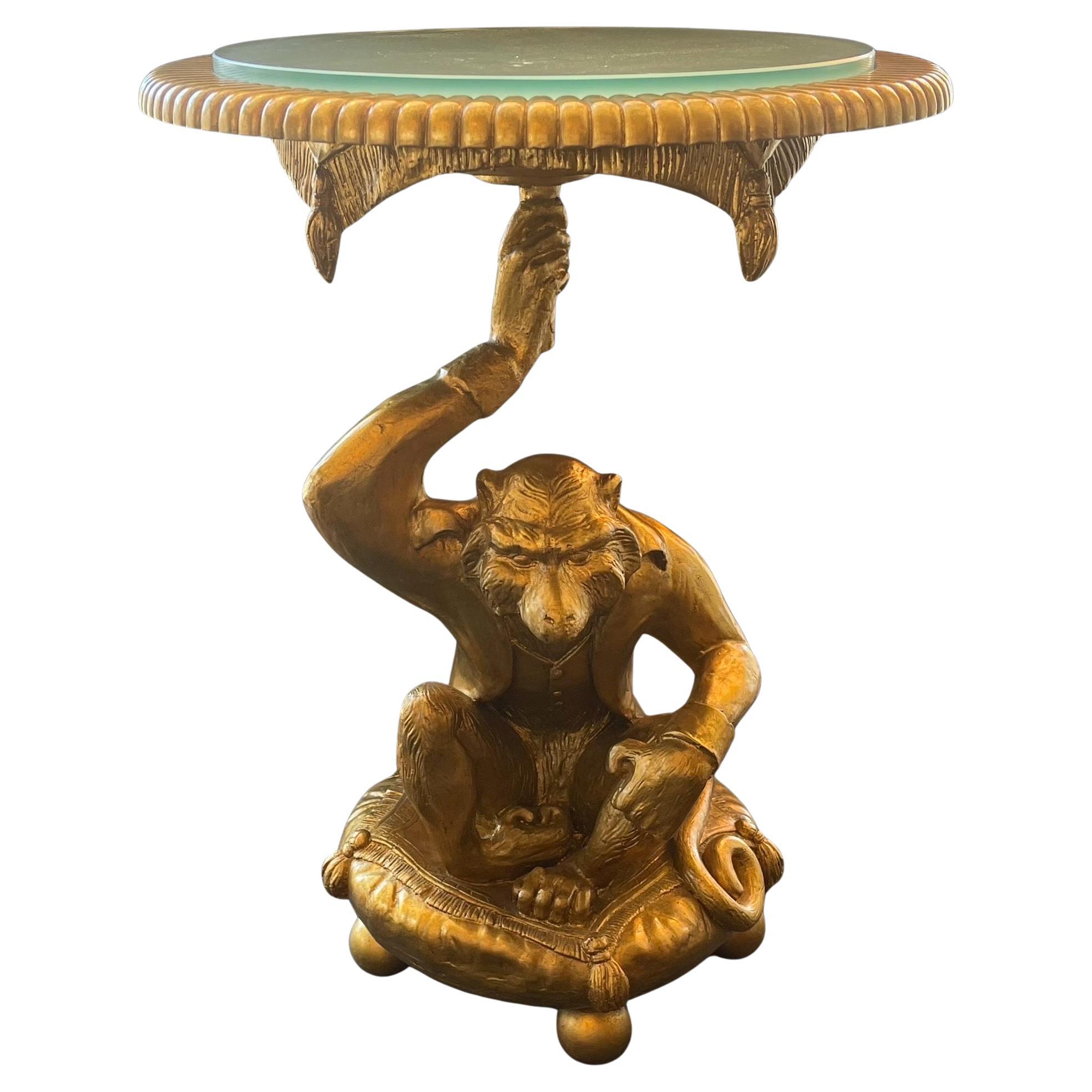 A Wonderful Pair Of Gold Leaf Carved Wood Monkey Figures Resting On Pillows With Tassels Holding Round Frosted Glass Table Tops