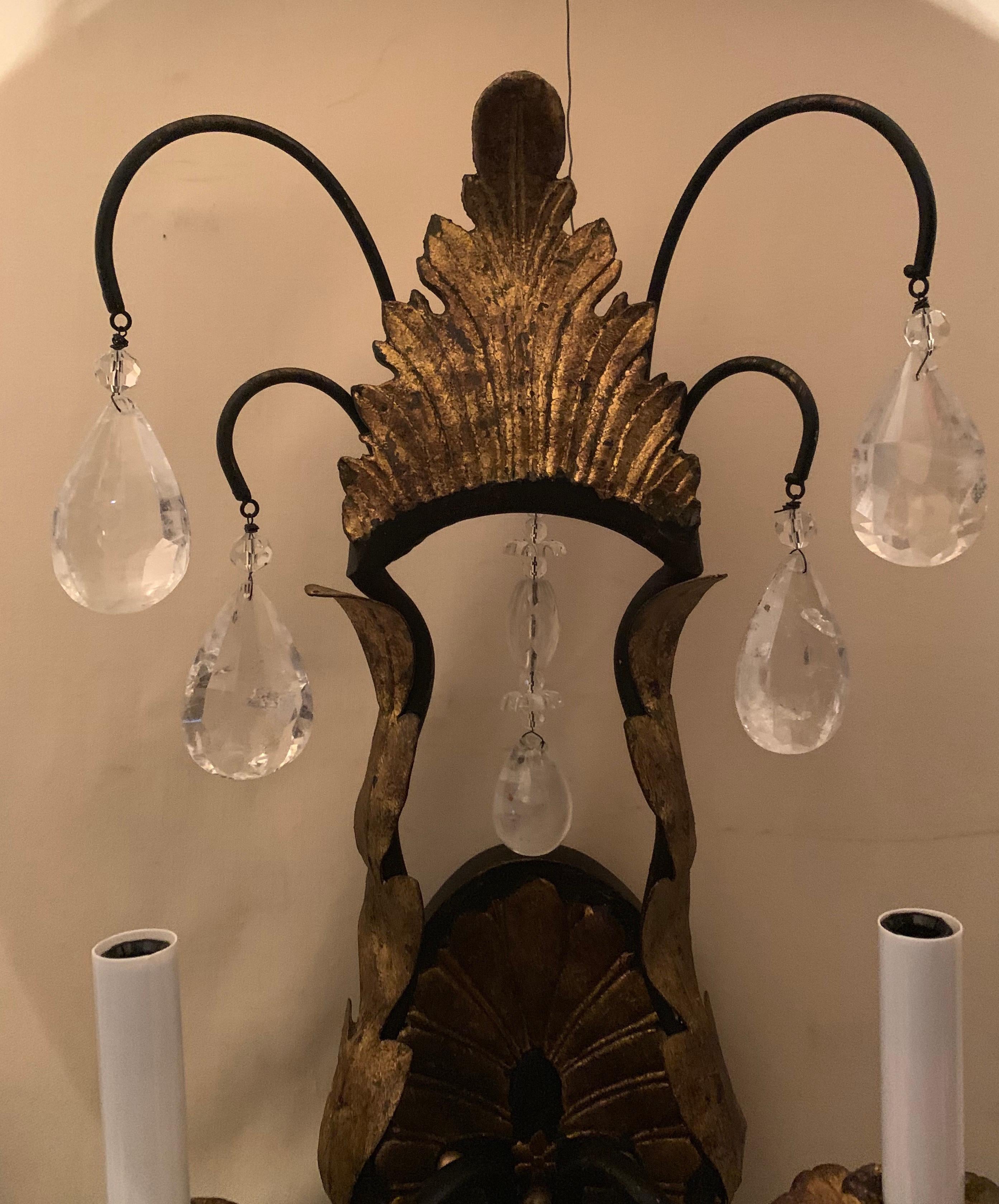 A wonderful pair of Louis XV style rock crystal and iron with gold gilt filigree sconces in the manner of Baguès with 2 candelabra sockets each completely rewired and ready to install.