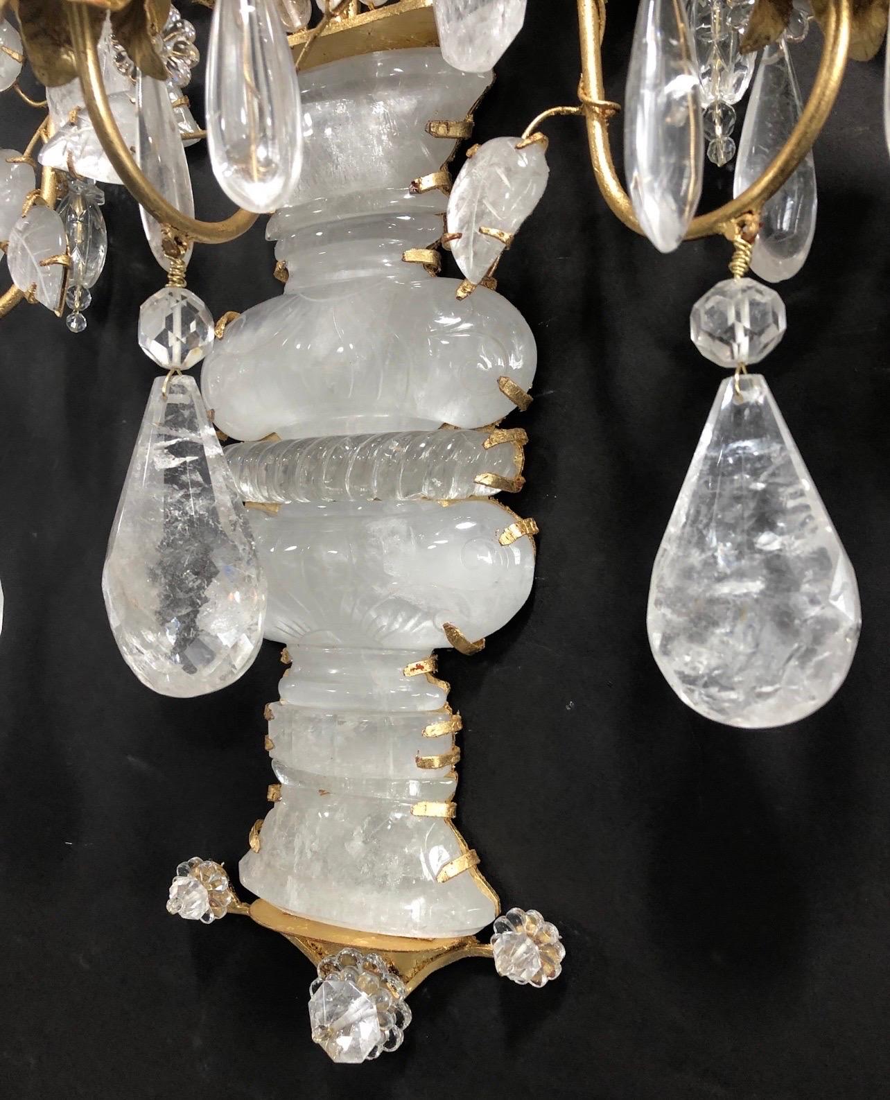 A wonderful pair of Maison Baguès Style large rock / quartz crystal 5 candelabra arm with urn form base leading to flowers and leaf bouquet sconces.
Wiring is Available For $500 For The Pair.
