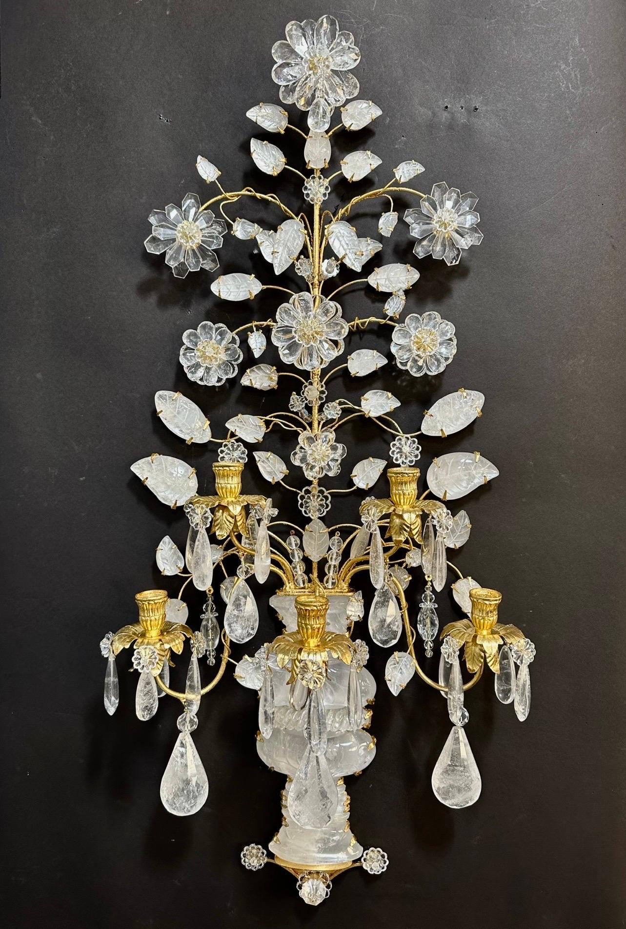 A wonderful pair of Maison Baguès style large rock / quartz crystal 5 candelabra arm with urn form base leading to flowers and leaf bouquet sconces.
Wiring is available for $500 for the pair.