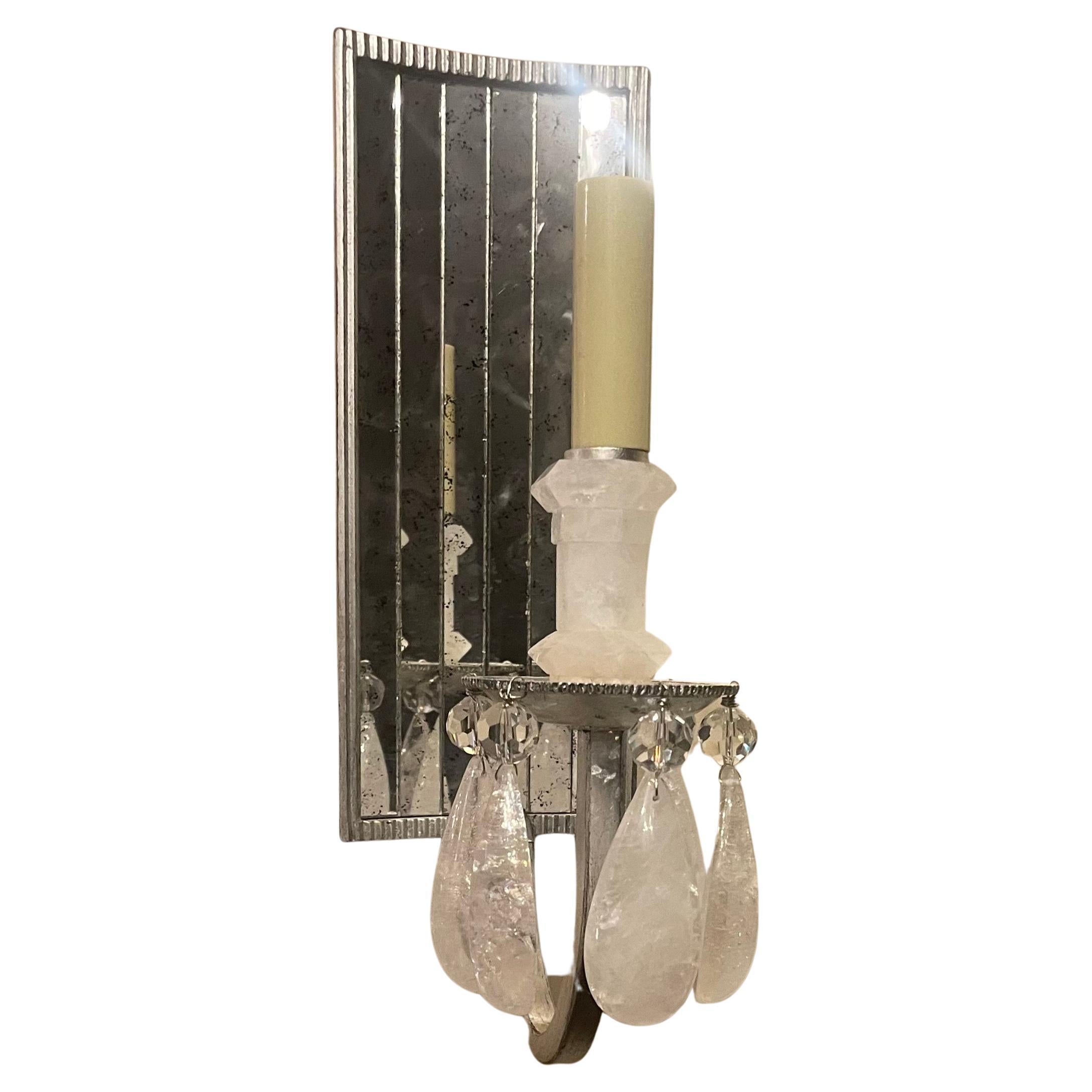 Una splendida coppia di lampade da parete con pannello a specchio anticato, alloggiamento in foglia d'argento e elementi in cristallo di rocca, ciascuna con una presa a candelabro, pronte per essere installate con le staffe di montaggio.