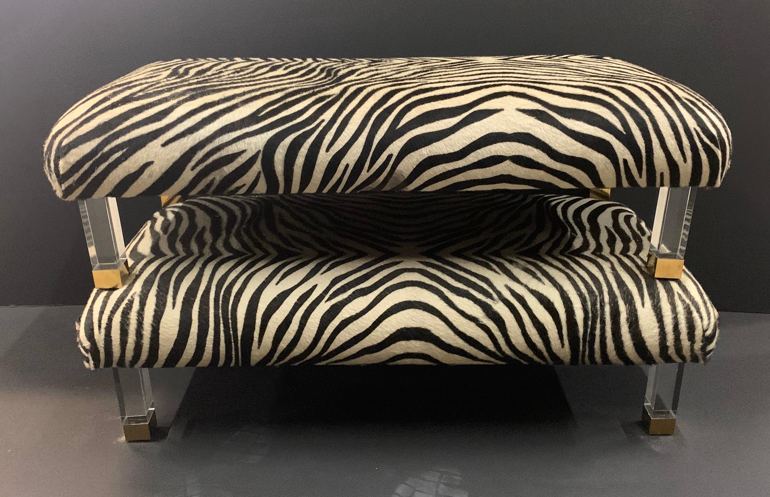 A wonderful pair of modern real zebra skin with Lucite brass legs ottomans foot stools benches, purchased from Lorin Marsh, NYC
Wear from Use, pictured.