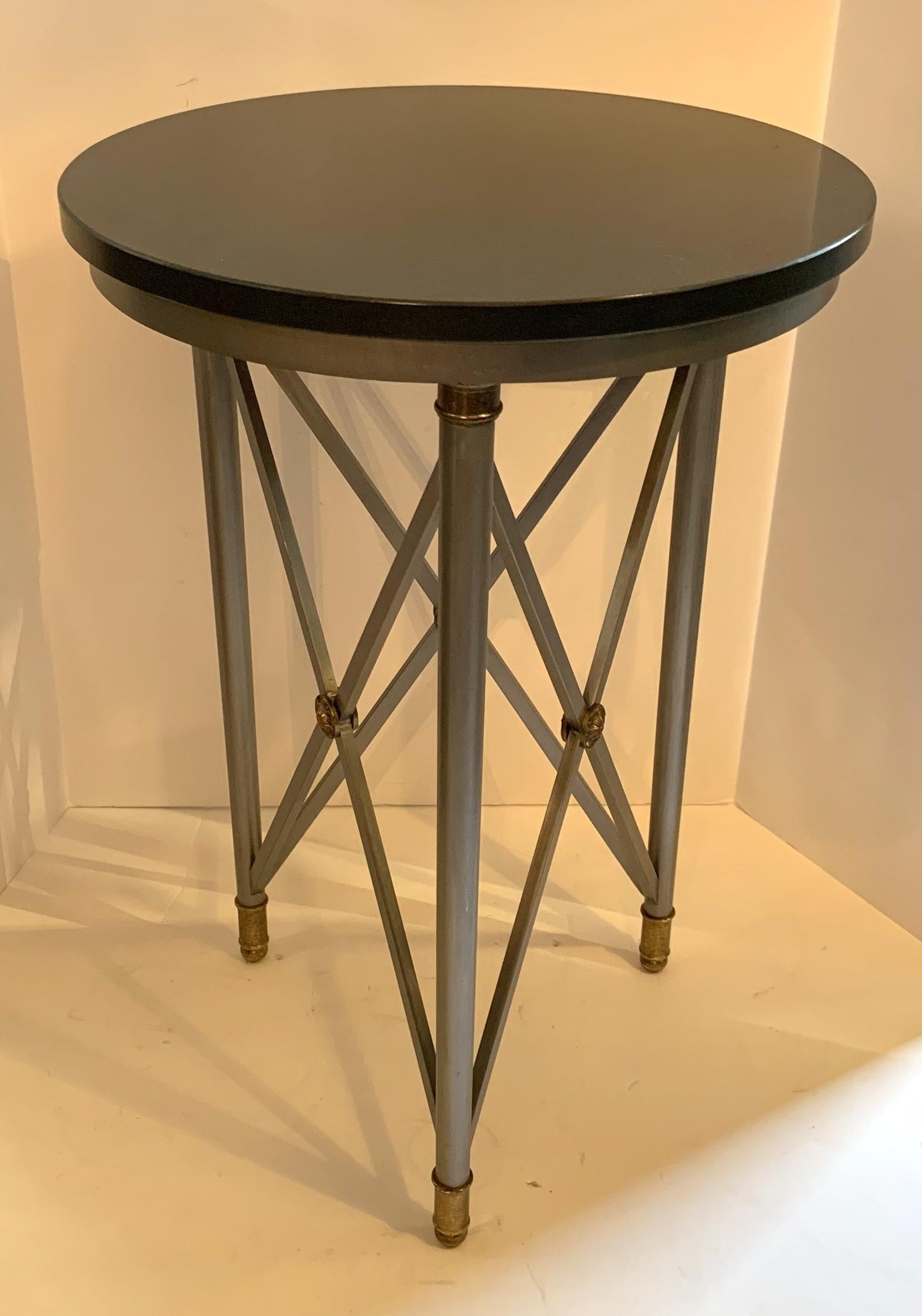 A wonderful pair of neoclassical style granite top, brushed steel and bronze ormolu-mounted X-form gueridon end tables.