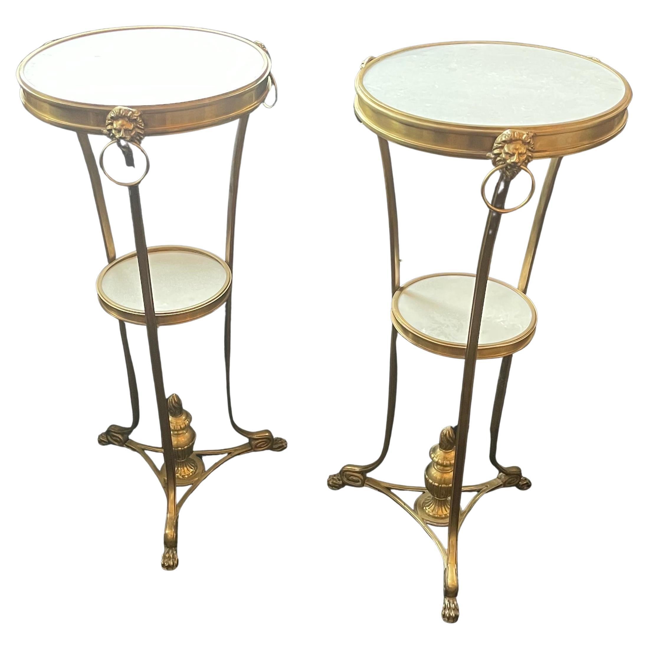 A wonderful pair of Empire, Regency, Neoclassical Ormolu bronze lions head and paw feet with white marble inset top two tier gueridon side tables.