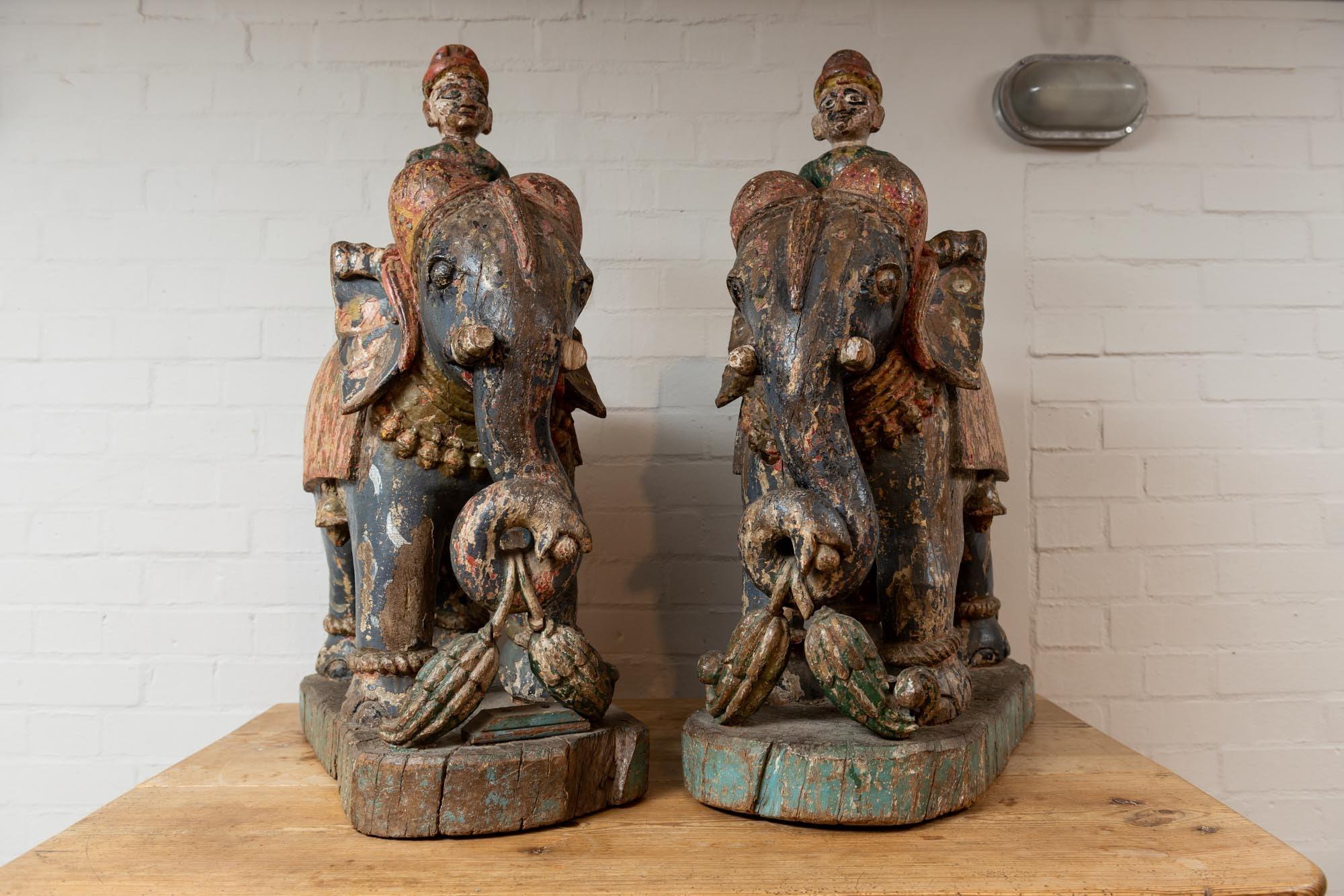 A pair of 19th century wooden elephants from the Rajasthan area in India with their original paint and vibrant colors. Originally they would have stood outside of a home by the front door.