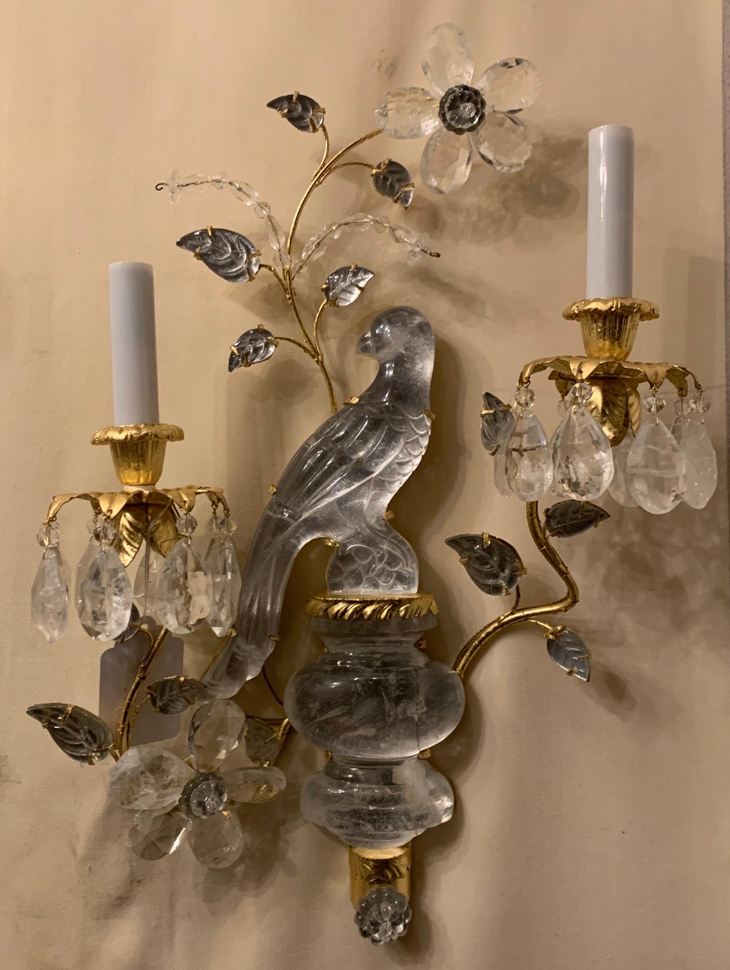 A wonderful pair of Baguès style two-arm rock crystal bird / parrot urn form gold gilt sconces adorned with leaves and flowers, newly rewired with candelabra sockets each pair has a right and left facing bird.

Second Pair Also Available