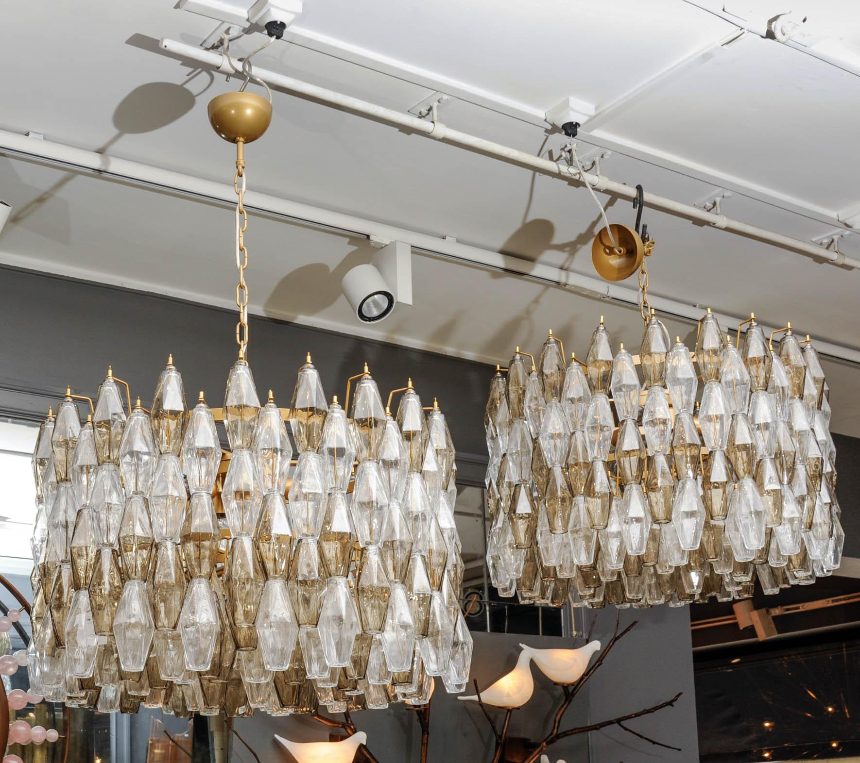 These wonderful chandeliers are made of glass from Venini. There are six bulbs on it.
