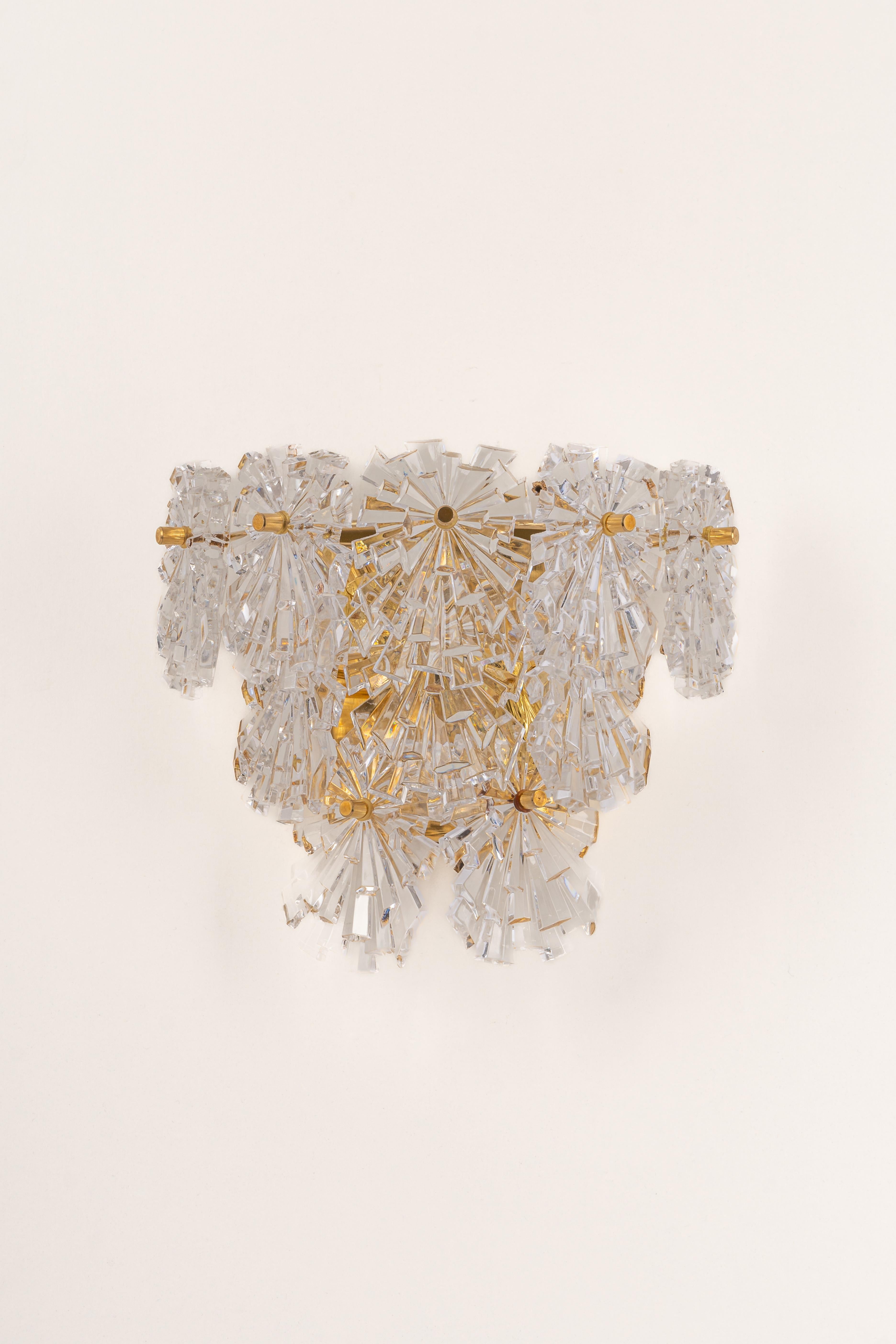 A stunning pair of golden sconces with crystal glasses, made by Kinkeldey, Germany, circa 1970-1979. It’s composed of crystal glass pieces on a brass frame.
Best of the 1970s from Germany.

High quality and in very good condition. Cleaned,