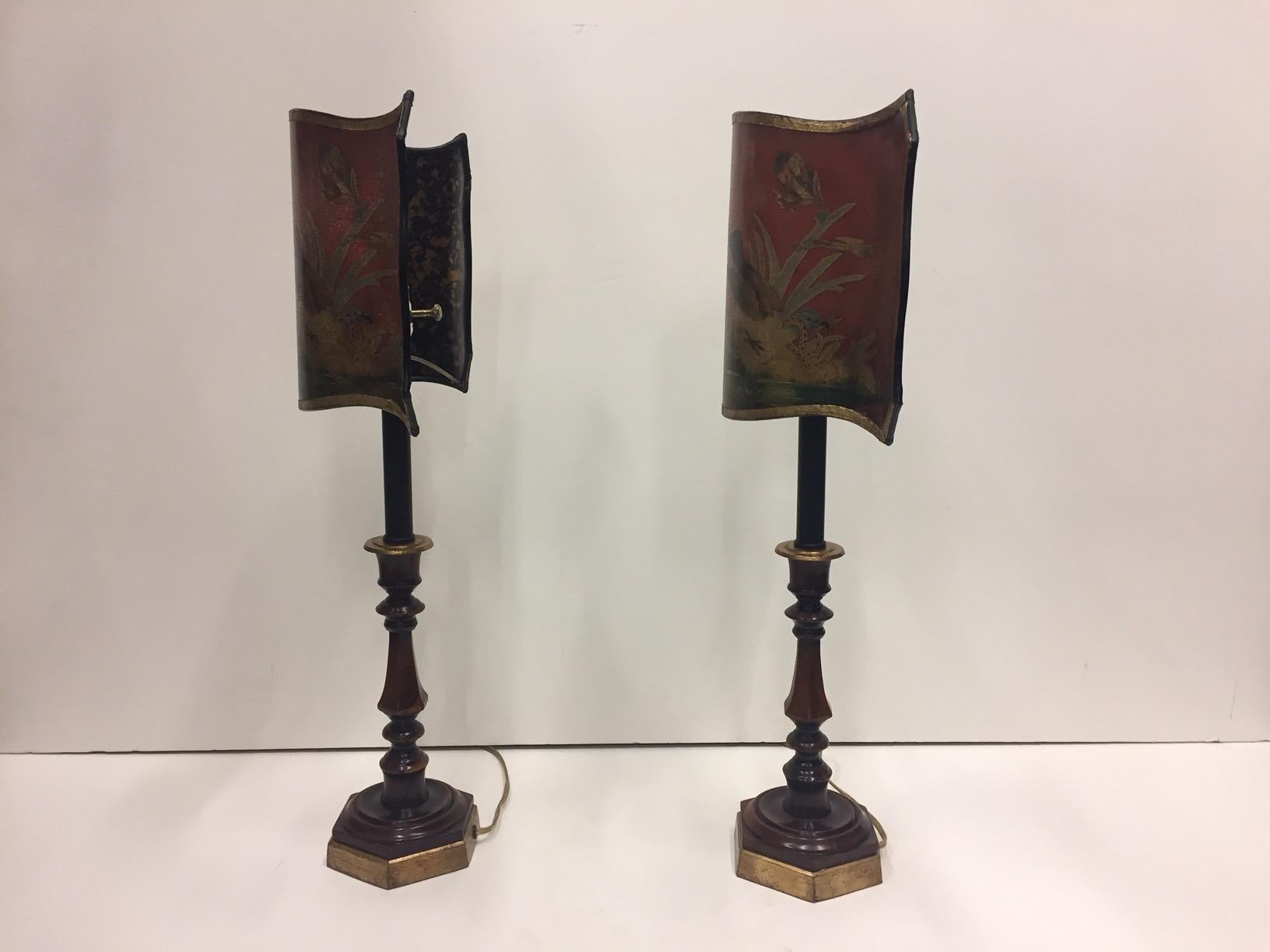 A wonderfully decorative pair of dark red candlestick lamps having gold embellishments and marvelously undulating decoupage shades with birds and foliage.
Shades are not removeable.