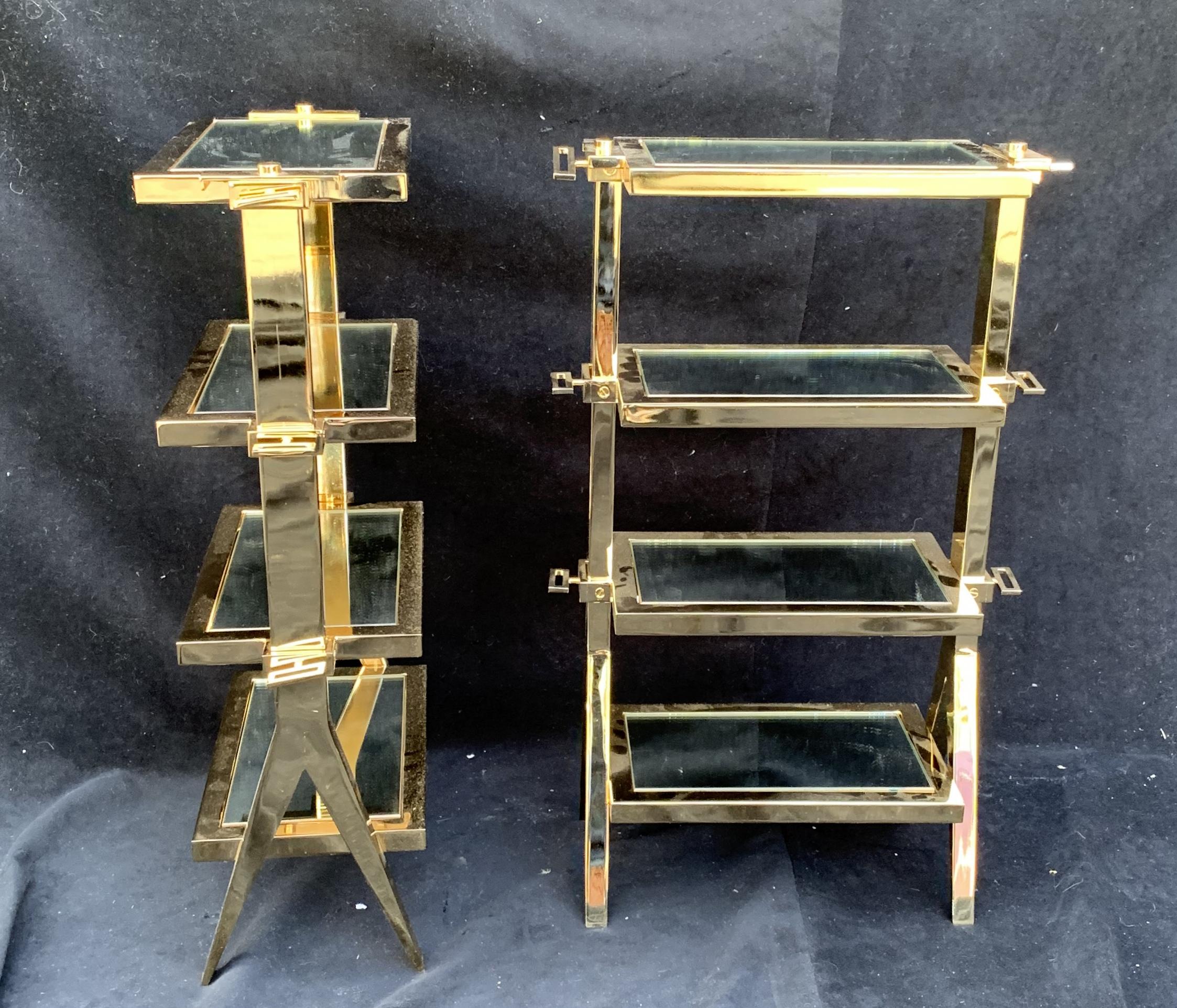 A wonderful Mid-Century Modern pair of four-tier polished brass / bronze inset with mirror shelves side tables from the world famous Lorin Marsh showroom.

Each sold separately.