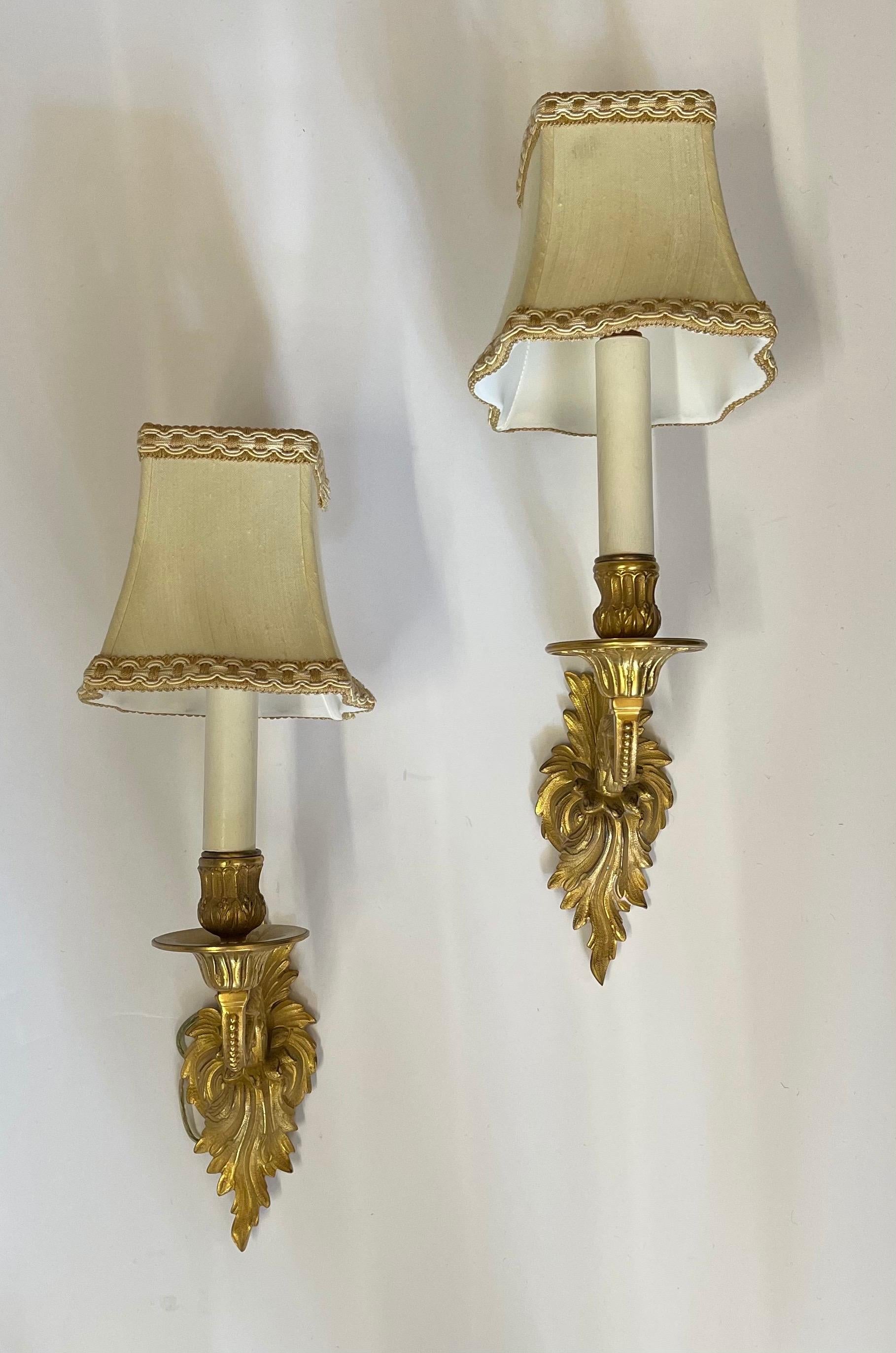 A wonderful pair of French doré bronze Rococo style single candelabrum arm sconces.
Rewired and ready to install.