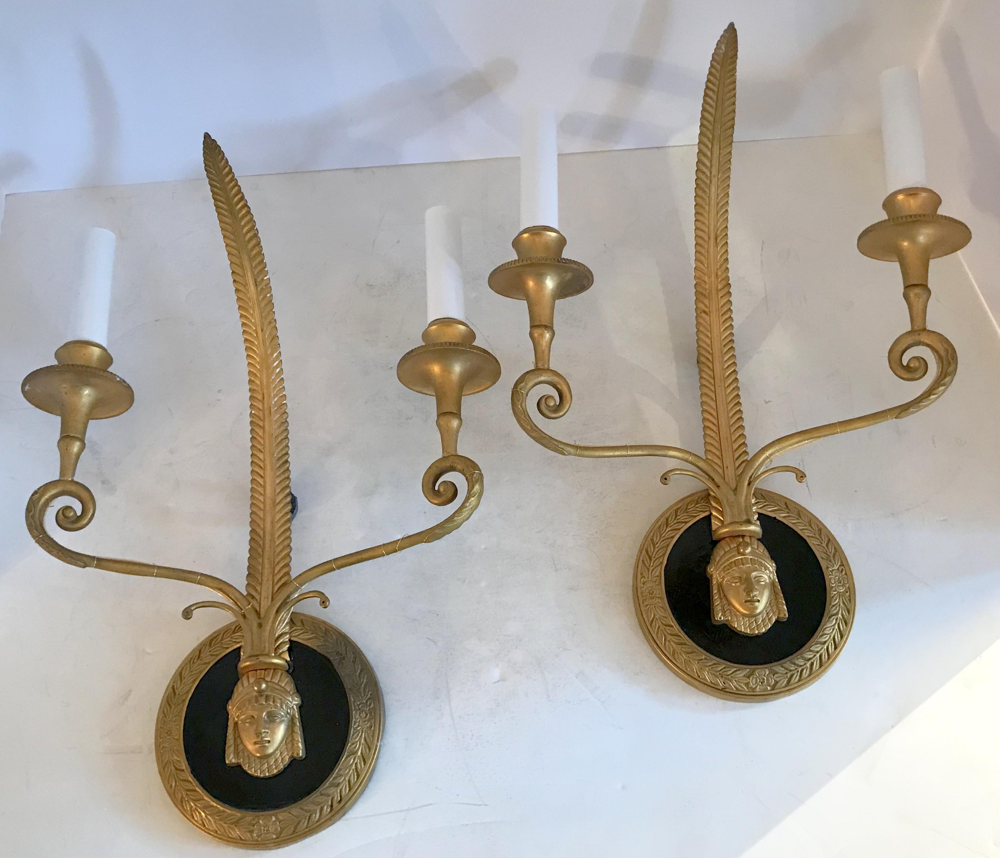 A wonderful pair of French Empire gilt and patinated bronze medusa figure neoclassical sconces.