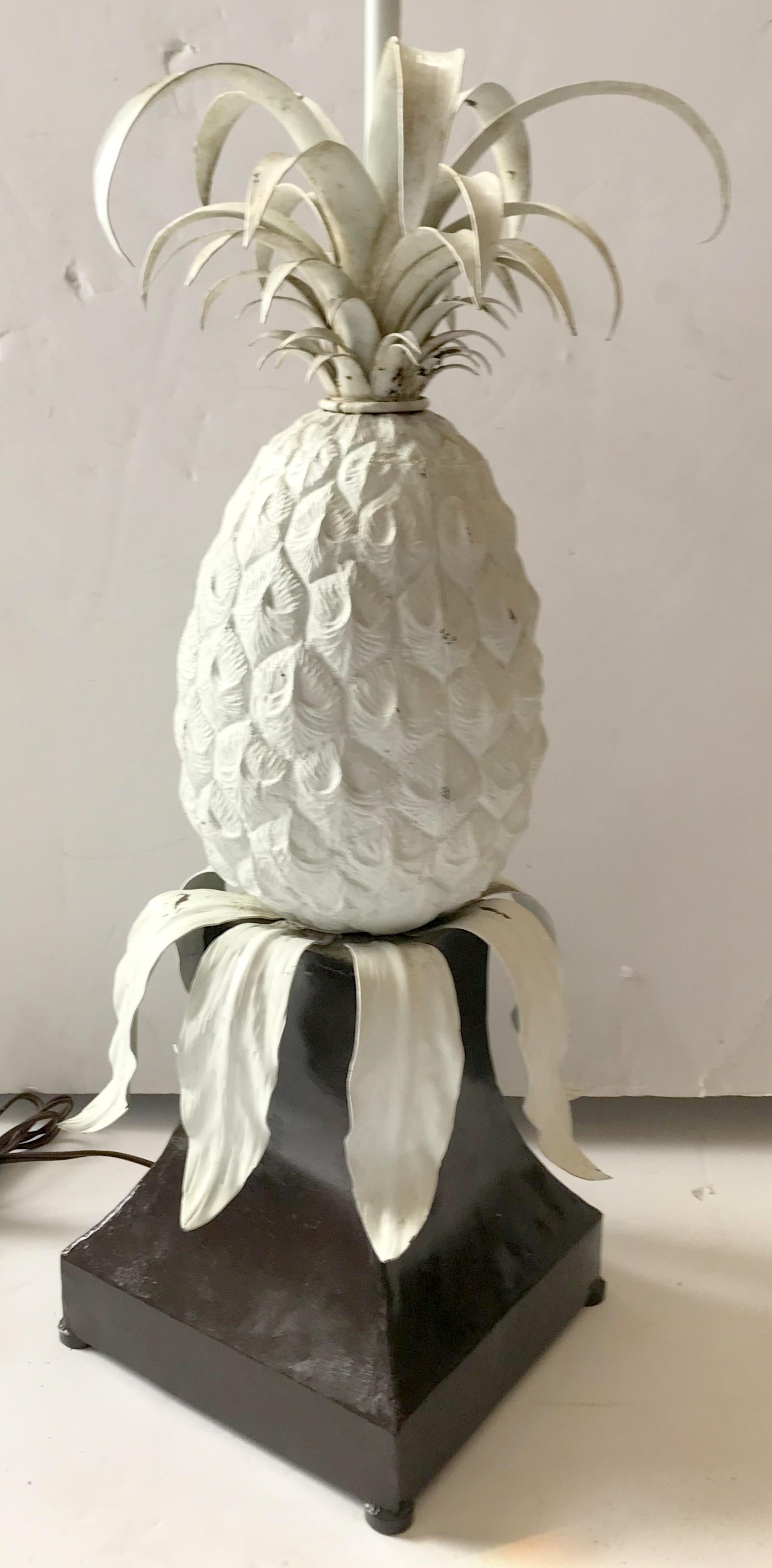 A wonderful pair of large pineapple form painted tole and metal table lamps on stand, very well made in Italy. Height is adjustable.