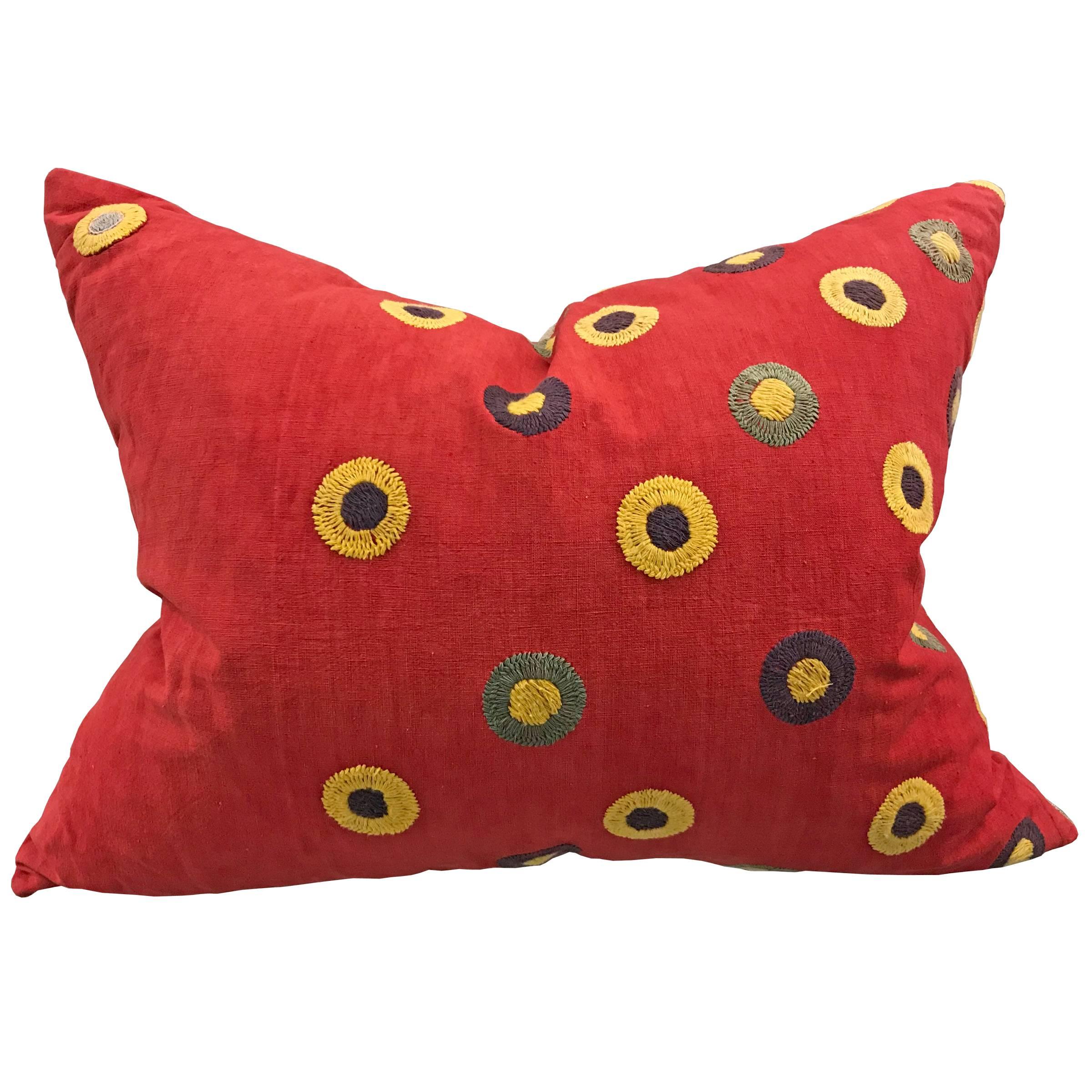 A wonderfully whimsical pair of vintage Uzbek pillows with hand-embroidered stylized flowers in an asymmetrical pattern on a beautiful handwoven red cotton ground. The backs are antique Italian linen. Filled with down.