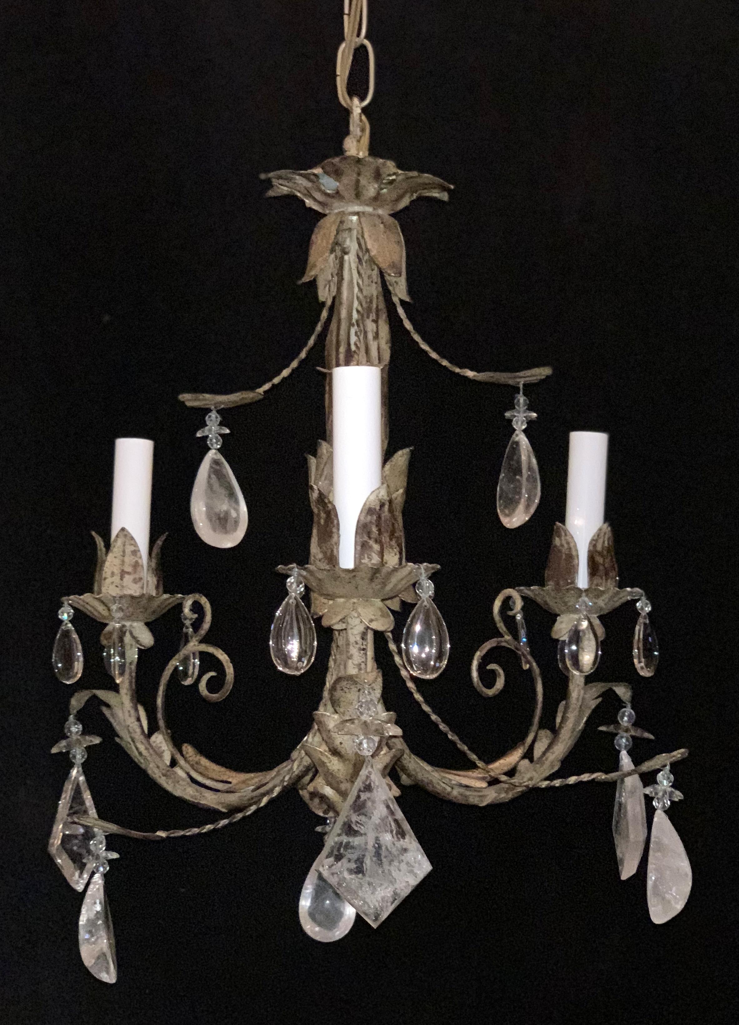 A wonderful vintage petite pair of midcentury Baguès style rock and star crystal, filigree and tassel form gilt tole chandeliers both rewired with 3 candelabra sockets each.