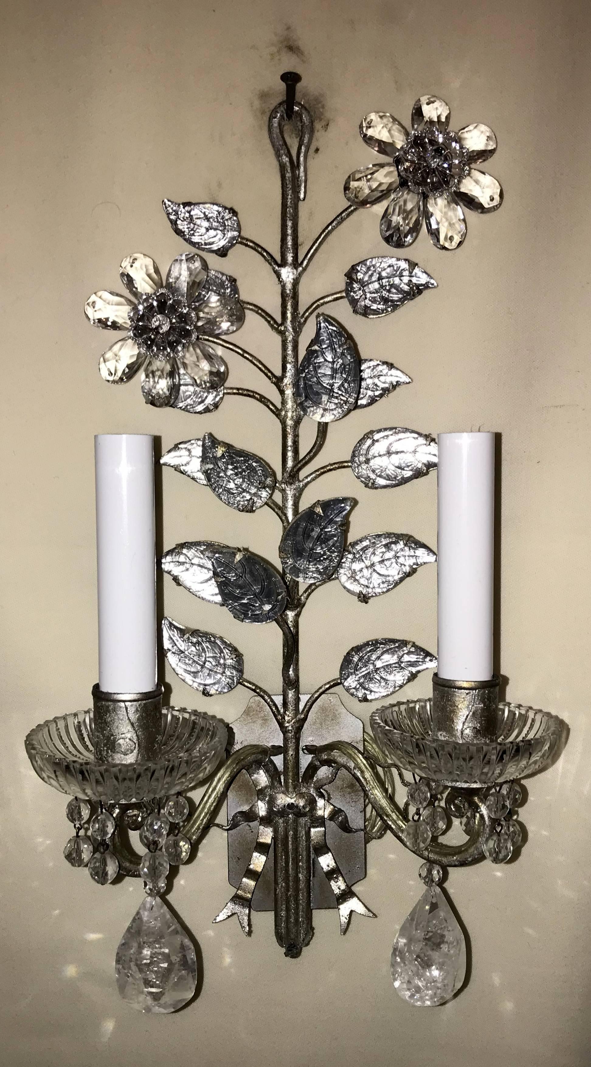 A wonderful pair of vintage French Baguès style, rock crystal drop silver leaf flower and bow back two-arm wall sconces with cut crystal bobeches and beaded drops.