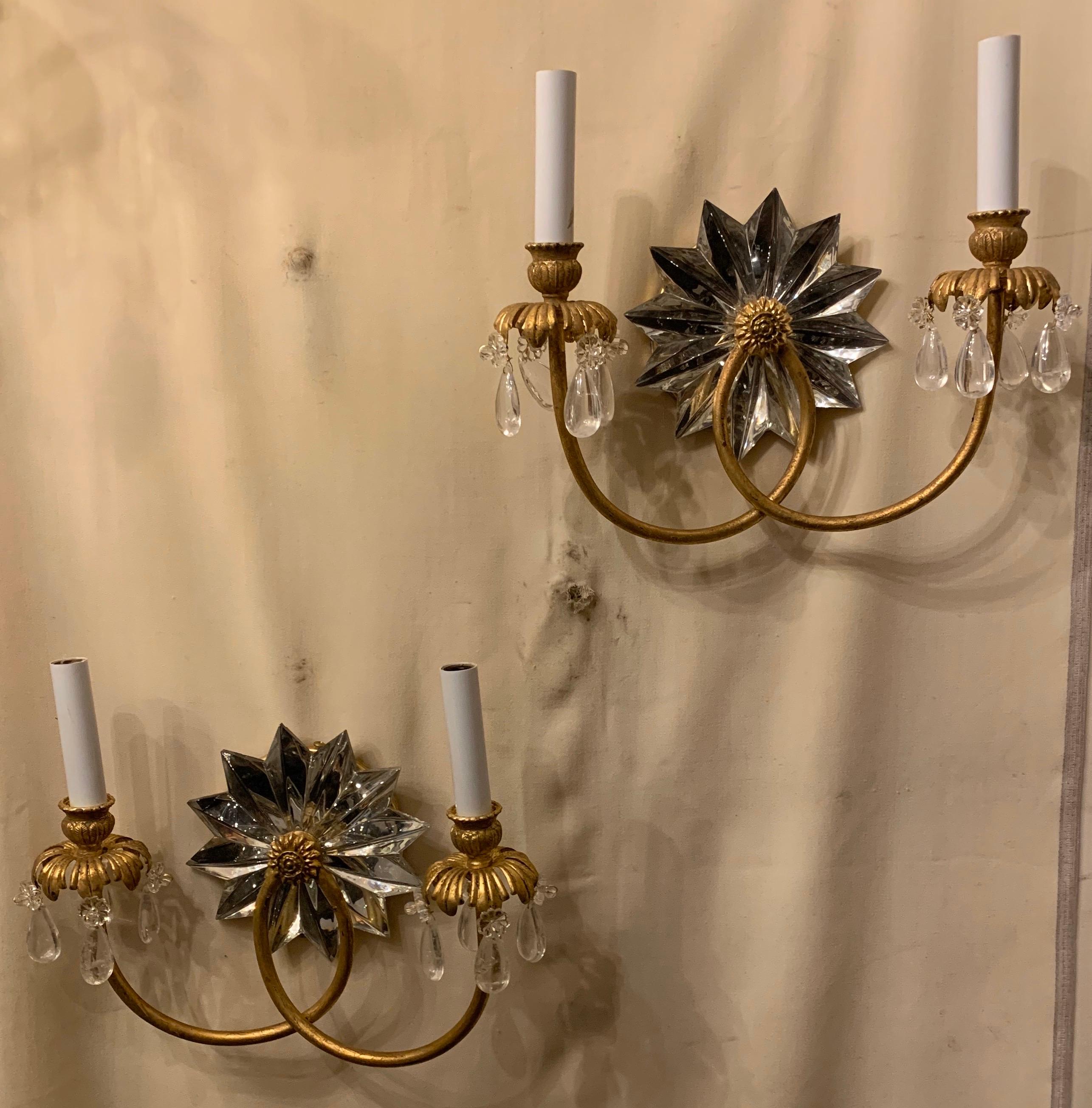 A wonderful pair of Mid-Century Modern star crystal center medallion adorned with rock crystals around the cups, in a gold gilt finish these sconces are in the manner of Baguès.
Completely rewired and come ready to install.