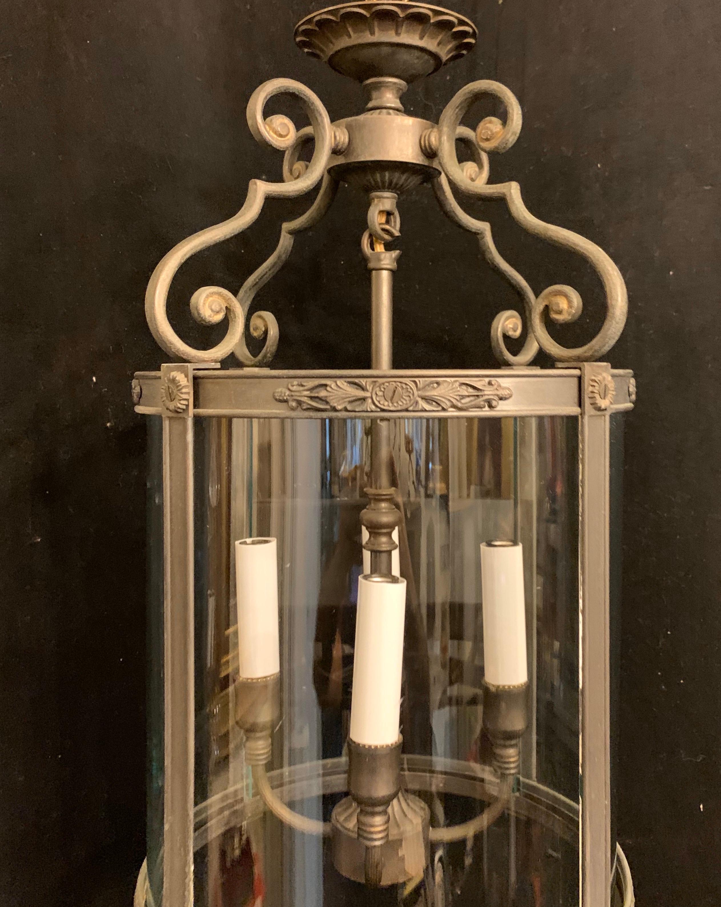 A wonderful patinated bronze petite rounded glass 3-light lantern fixture.