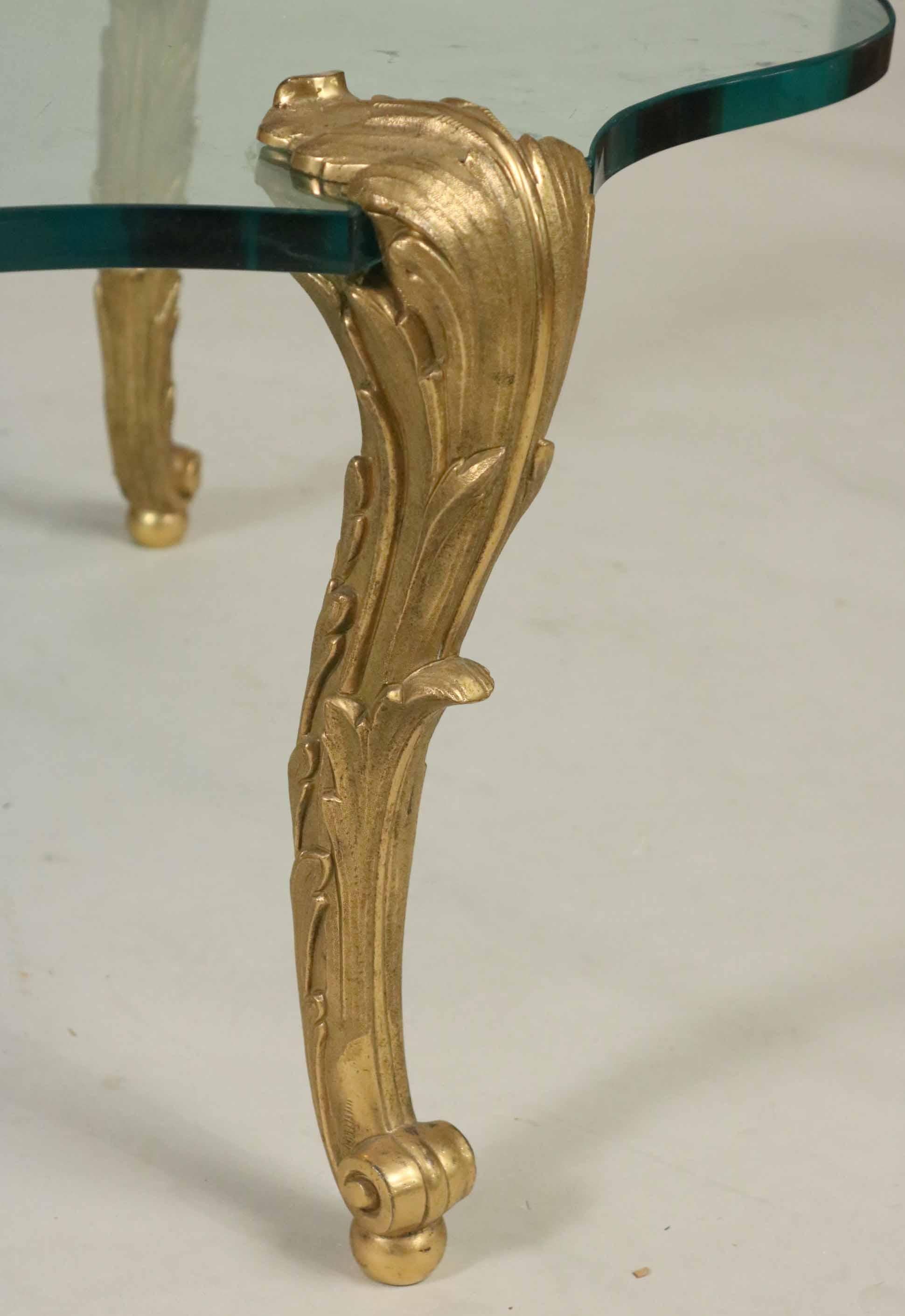 A wonderful P.E. Guerin gilt-bronze & oval glass coffee cocktail cartouche form table,
Marked under each foot, P.E. Guerin Inc, New York,
Measures: 16