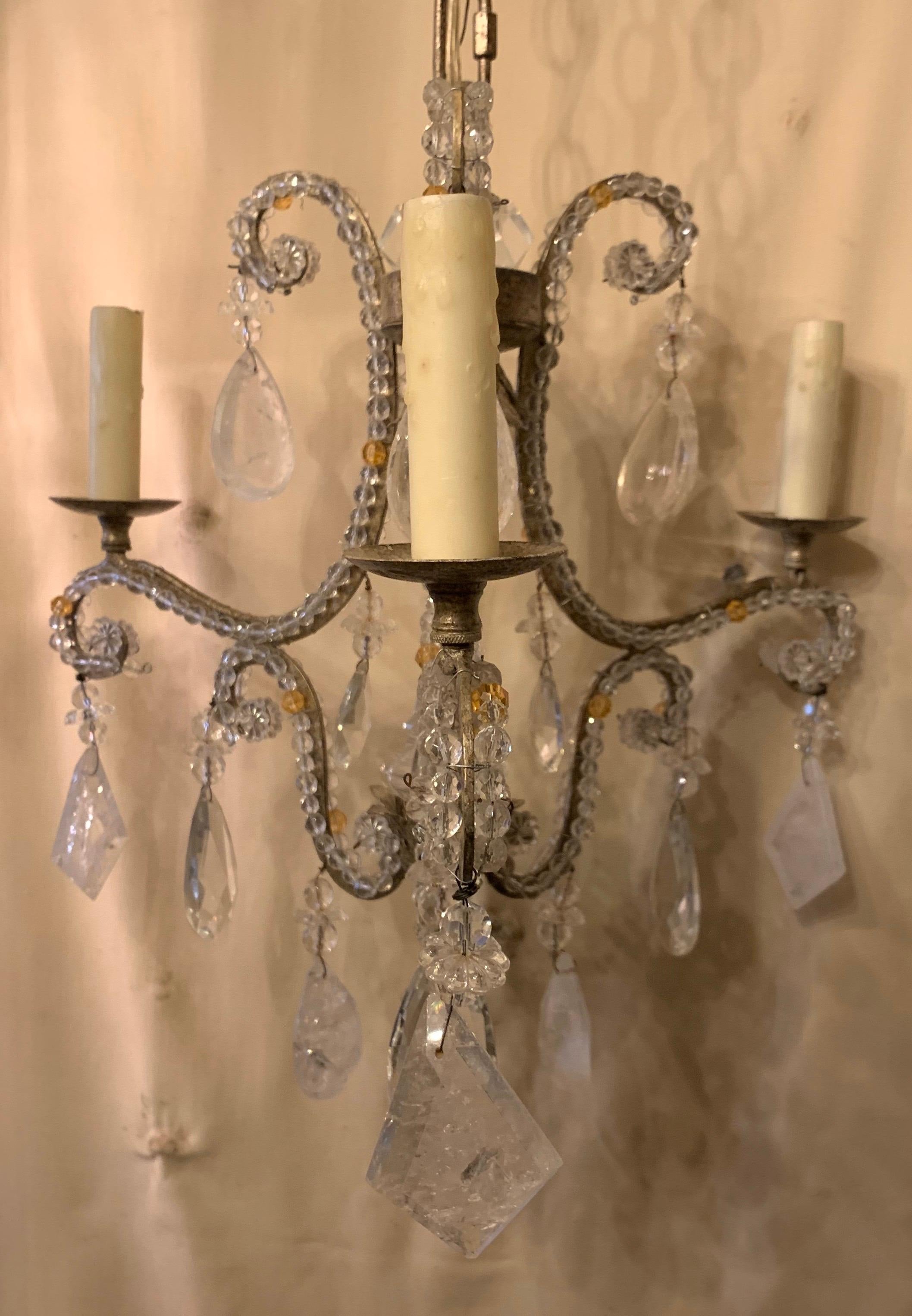 A wonderful Baguès style rock crystal, antique silver gilt and crystal beaded petite chandelier 3 candelabra light fixture centered with a crystal spike and finished on the bottom with a rock crystal ball.

Actual fixture measures 17