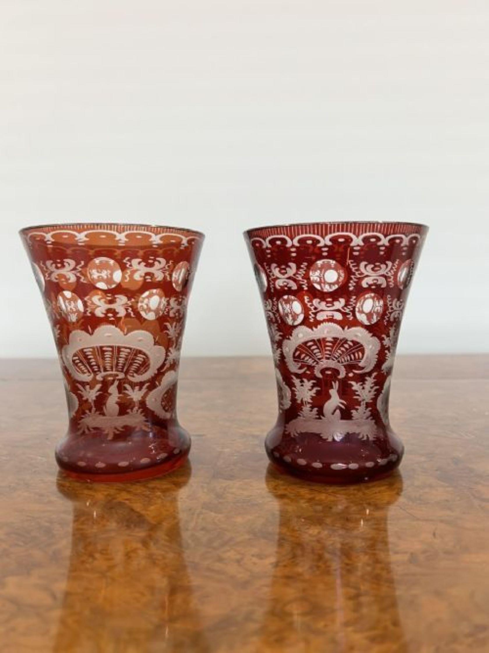 Wonderful quality pair of antique Victorian beakers having the flared red and clear glass tapering bowls with etched stag, rabbit, pagoda and church decoration amongst roundels and scrolls 