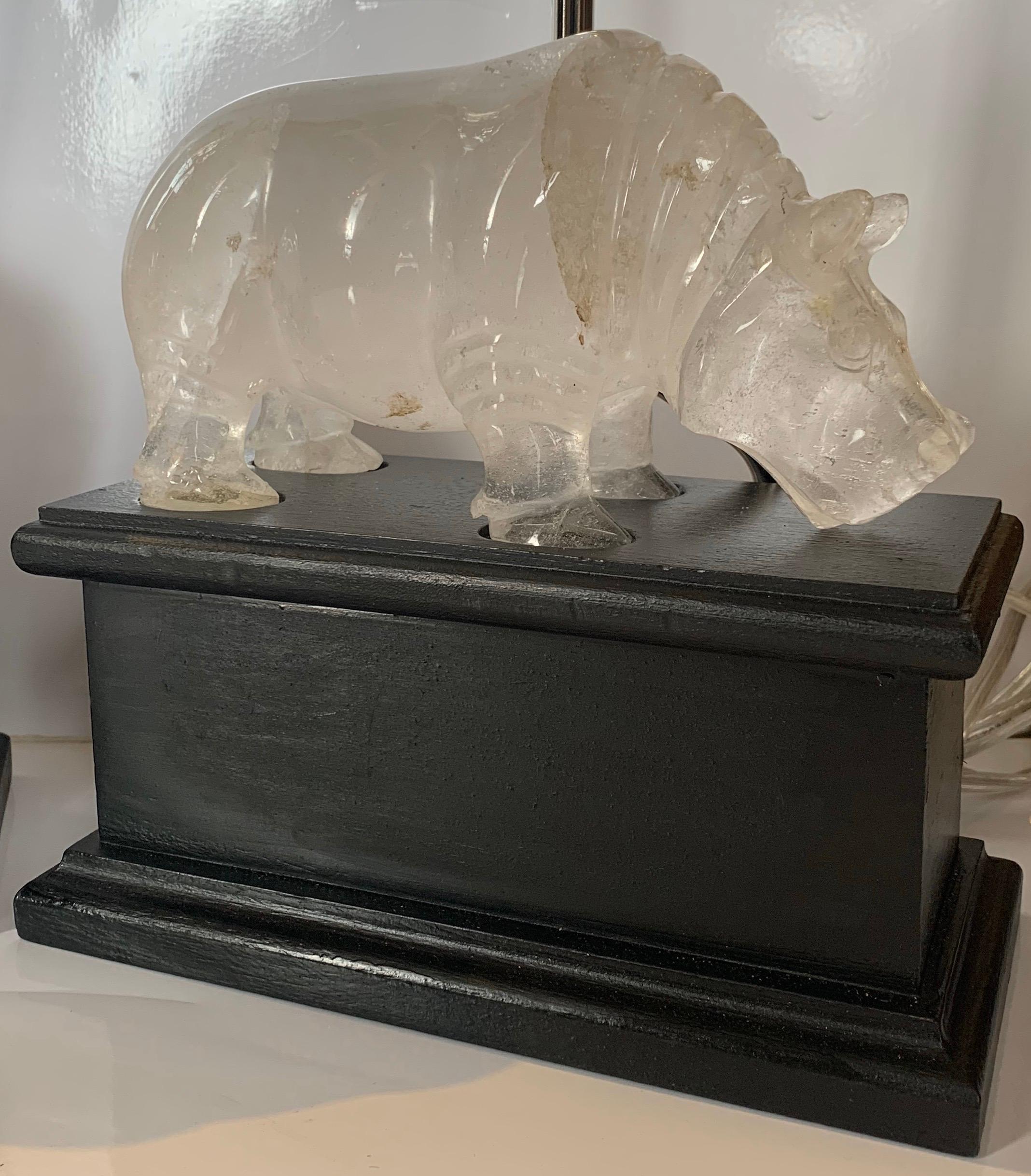 A wonderful and rare pair of rock crystal hippopotamus figure table lamps on black bases with new polished nickel hardware, they have completely been rewired.
One hippo with repair to back ear.