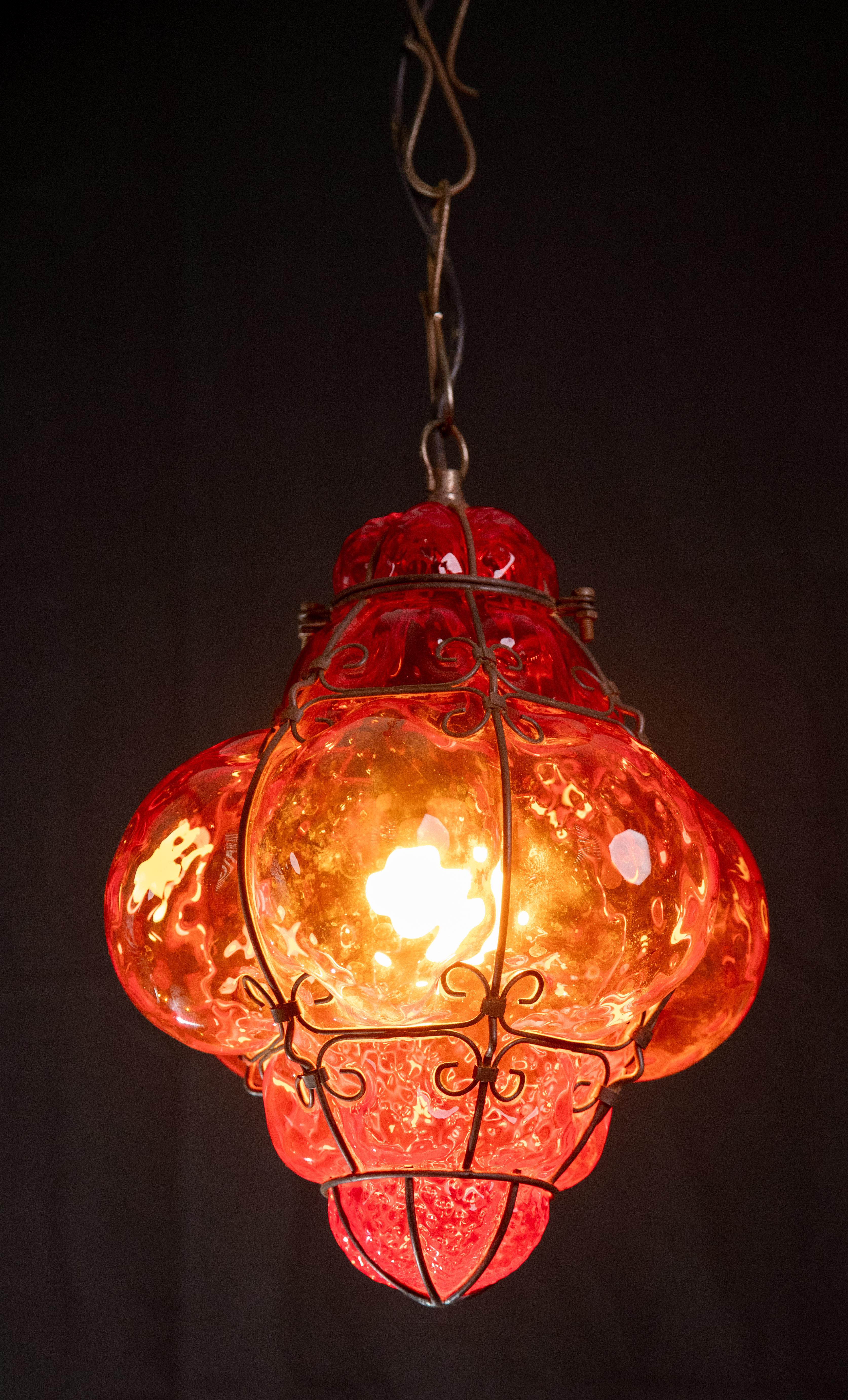 A beautiful light for hallways, entryways and living rooms, this hand-blown glass lantern is attributed to Seguso. The glass is a bright red. As always, these beautiful lanterns create their own magic and show incredible craftsmanship.

The lantern
