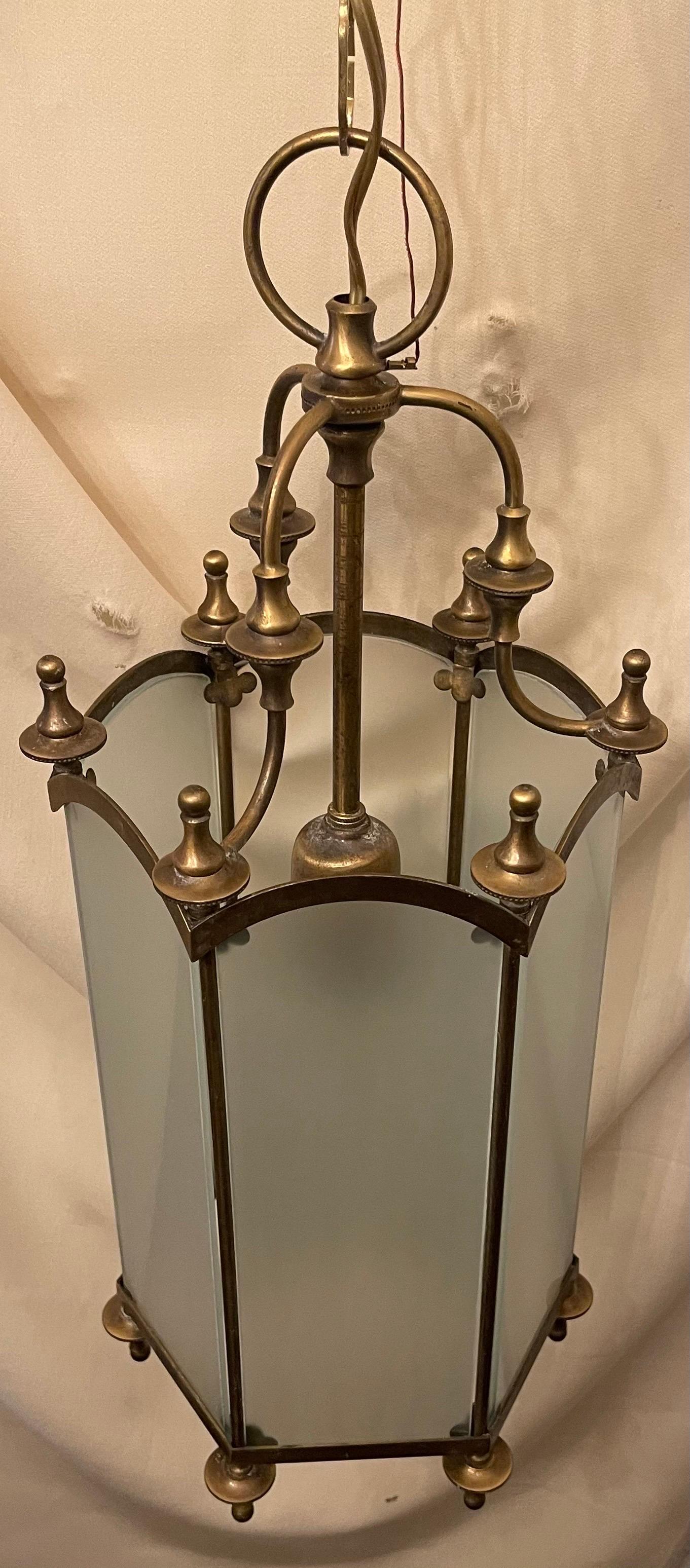 A wonderful regency style bronze / brass with frosted glass panel hexagon shaped lantern fixture finished with finials.