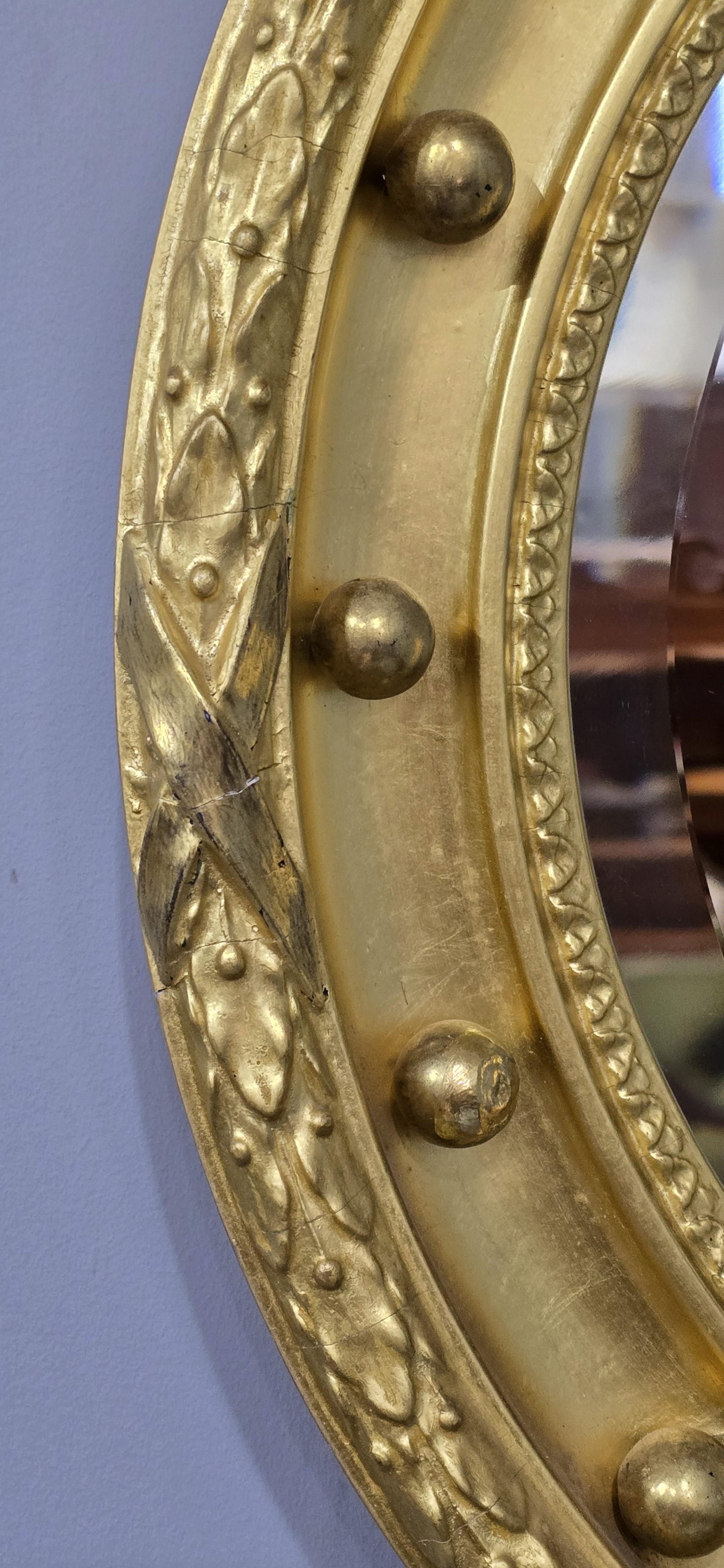 An outstanding Regency gilt mirror, oil and water gilded, pretty leaf and bow detailing, round with bevelled glass mirror plate, in lovely condition.

24.5