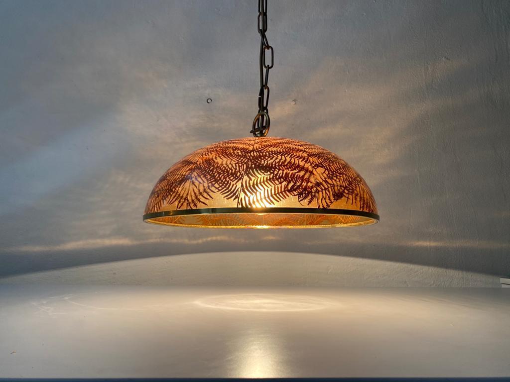 Wonderful resin shade with real leafs pendant lamp, 1970s Italy
There are brass frame.

The lamp is in very good vintage condition. 

This lamp works with E27 light bulb.
Wired and suitable to use with 220V and 110V for all