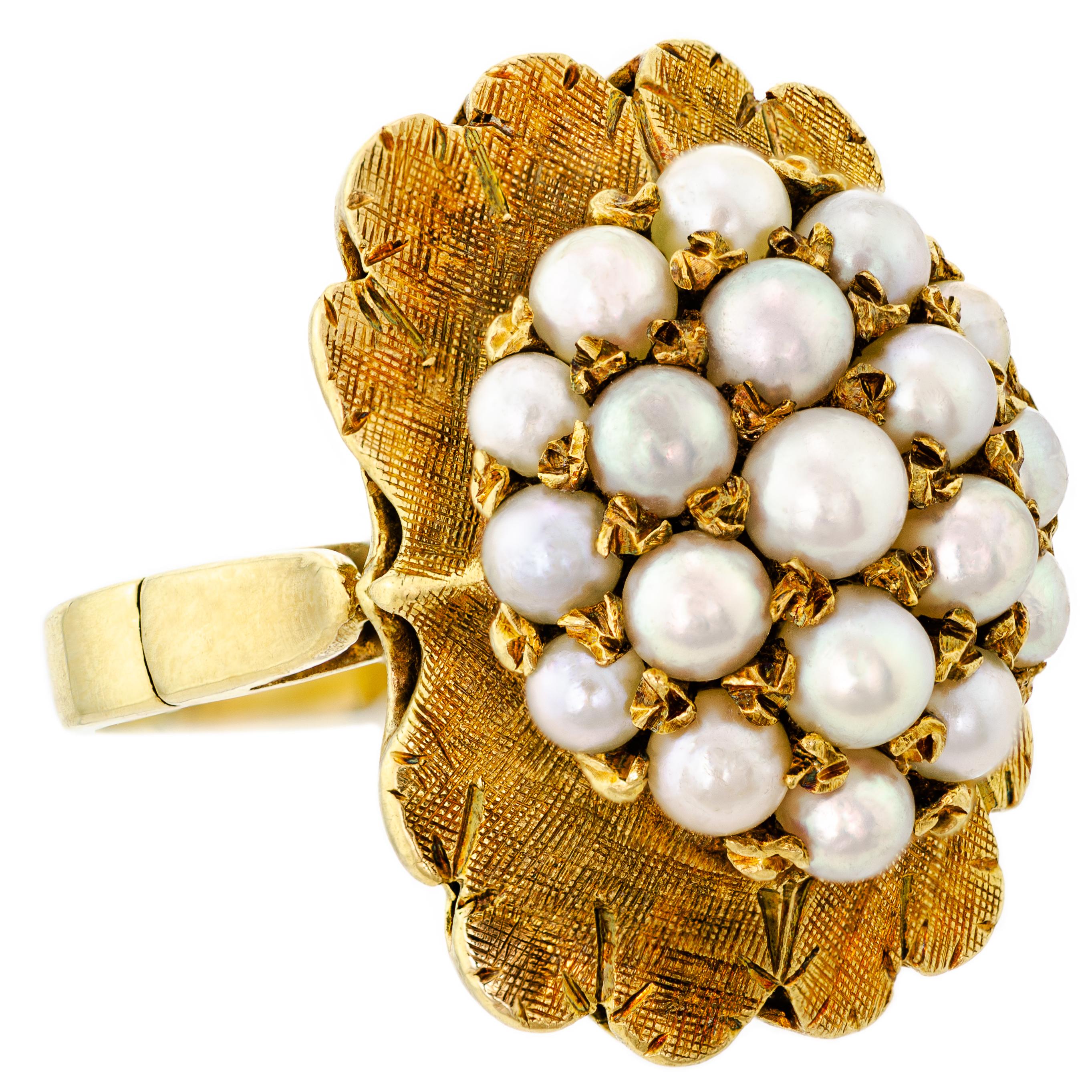 This stunning ring is a true representation of Retro-inspired fashion from the 1940s. It features a meticulously crafted dome bombe style setting with a cluster of round cultured pearls prong set in the center. The ring is made of 14kt yellow gold,