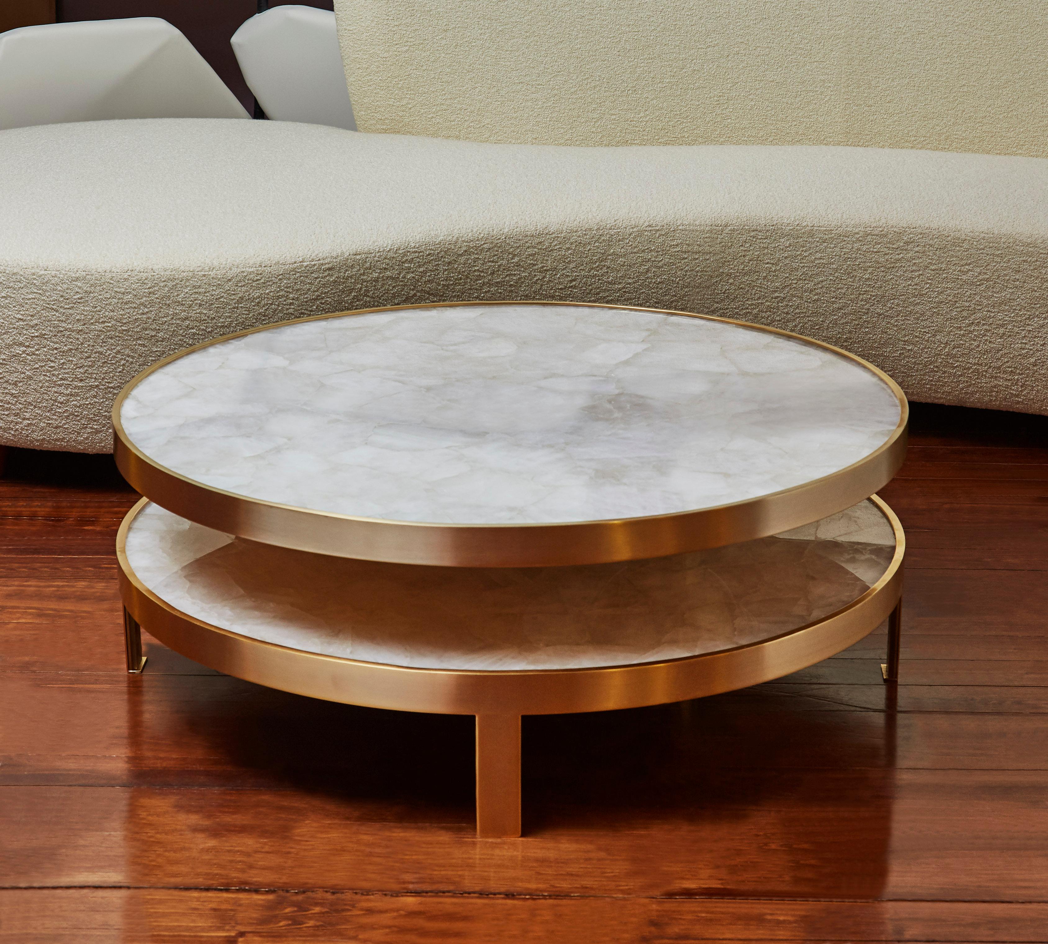 This coffee table is composed by two rock crystal tops, circled with brass. The structure is made of patinated brass, the upper plate is pivoting. Creation by Studio Glustin, France, 2019.
