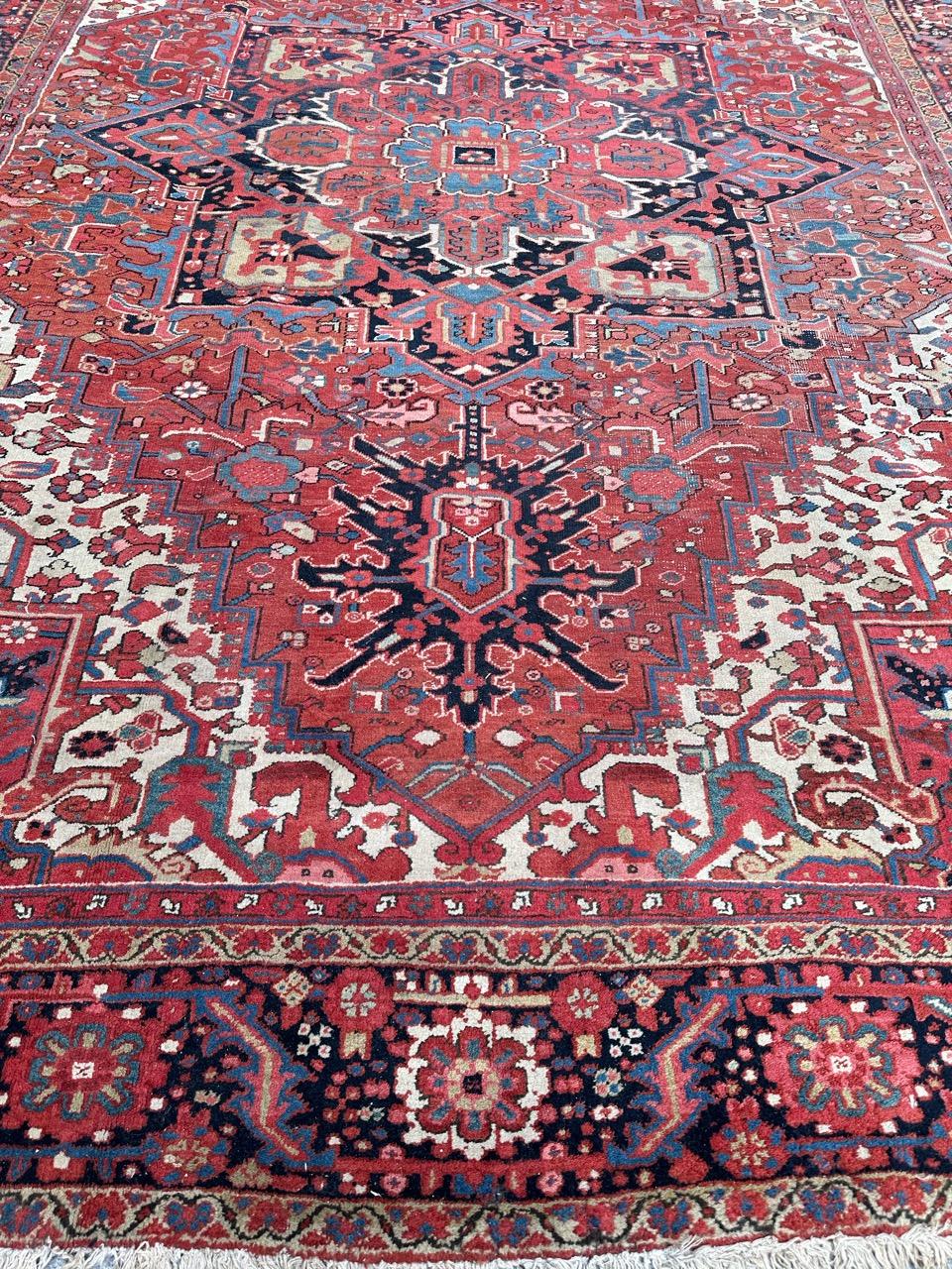 Discover a magnificent antique Heriz-style rug, boasting exquisite geometric and decorative patterns in rich, natural hues. This masterpiece is meticulously hand-knotted with sumptuous wool velvet on a cotton foundation. 

At its center, a