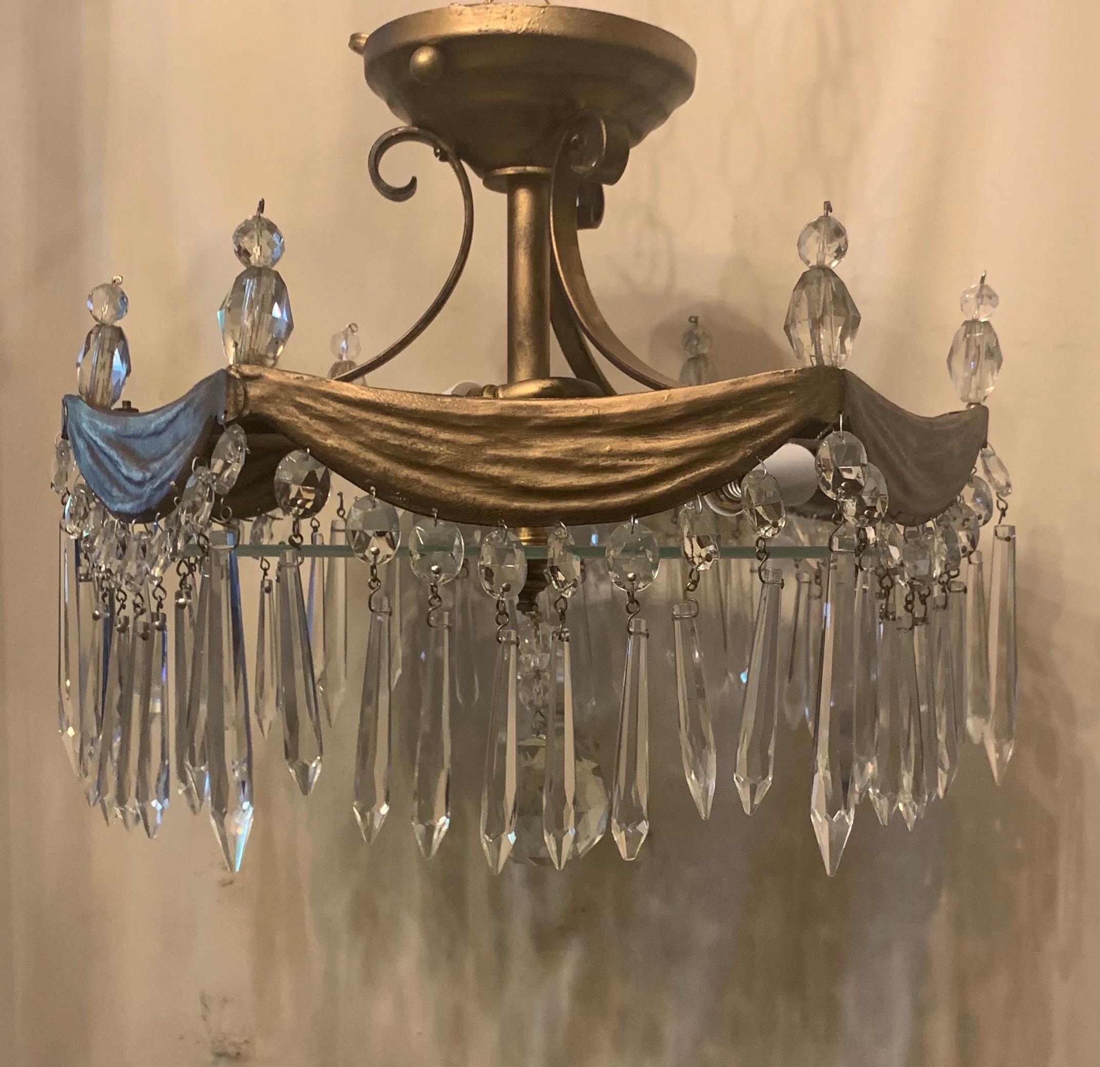 A wonderful semi flush mount bronze drape swag with hanging crystal pendant petite 3 candelabra light chandelier.