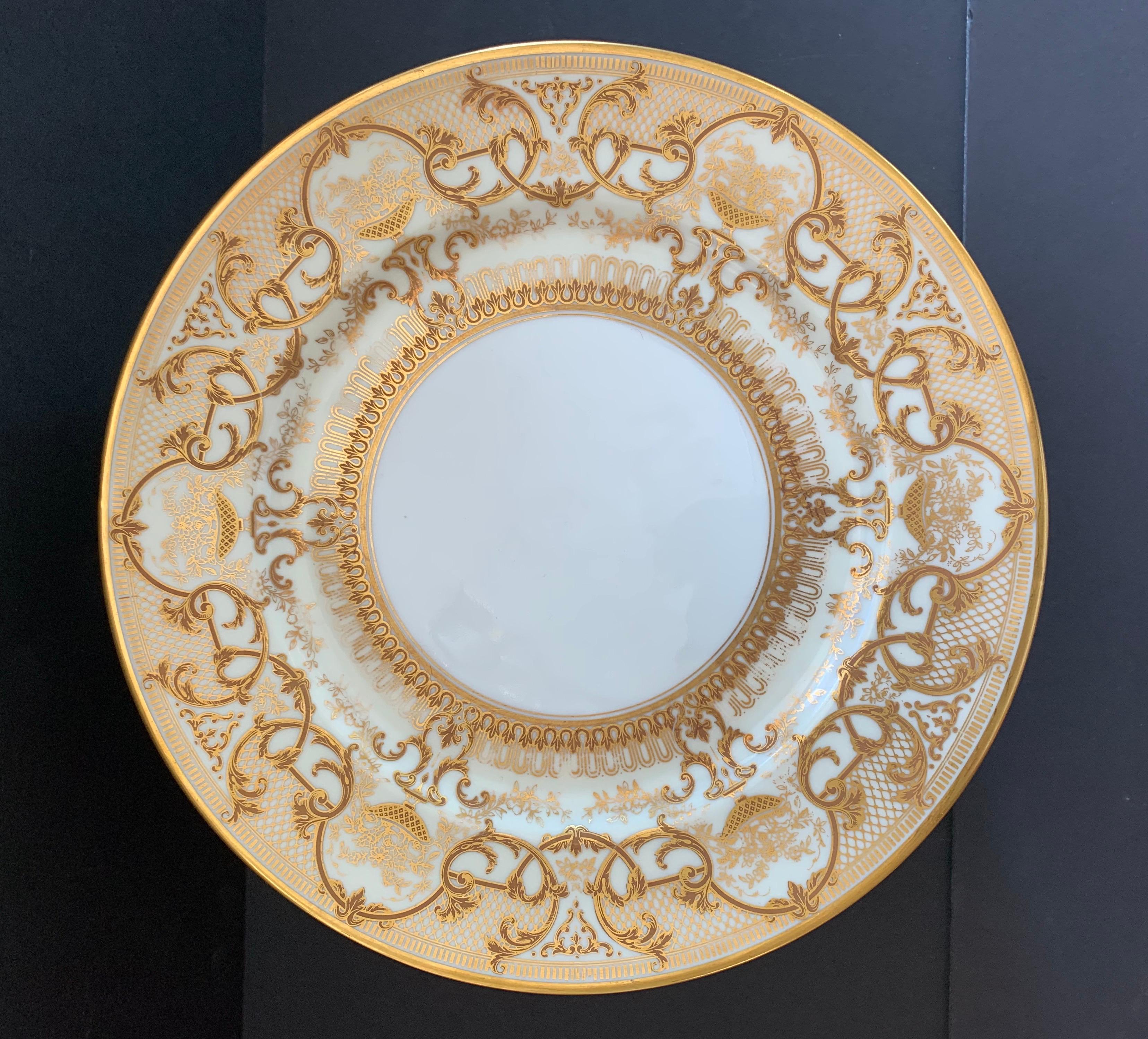 A wonderful service of plates set of 12 Limoges France white with gold flower bouquet design dishes.