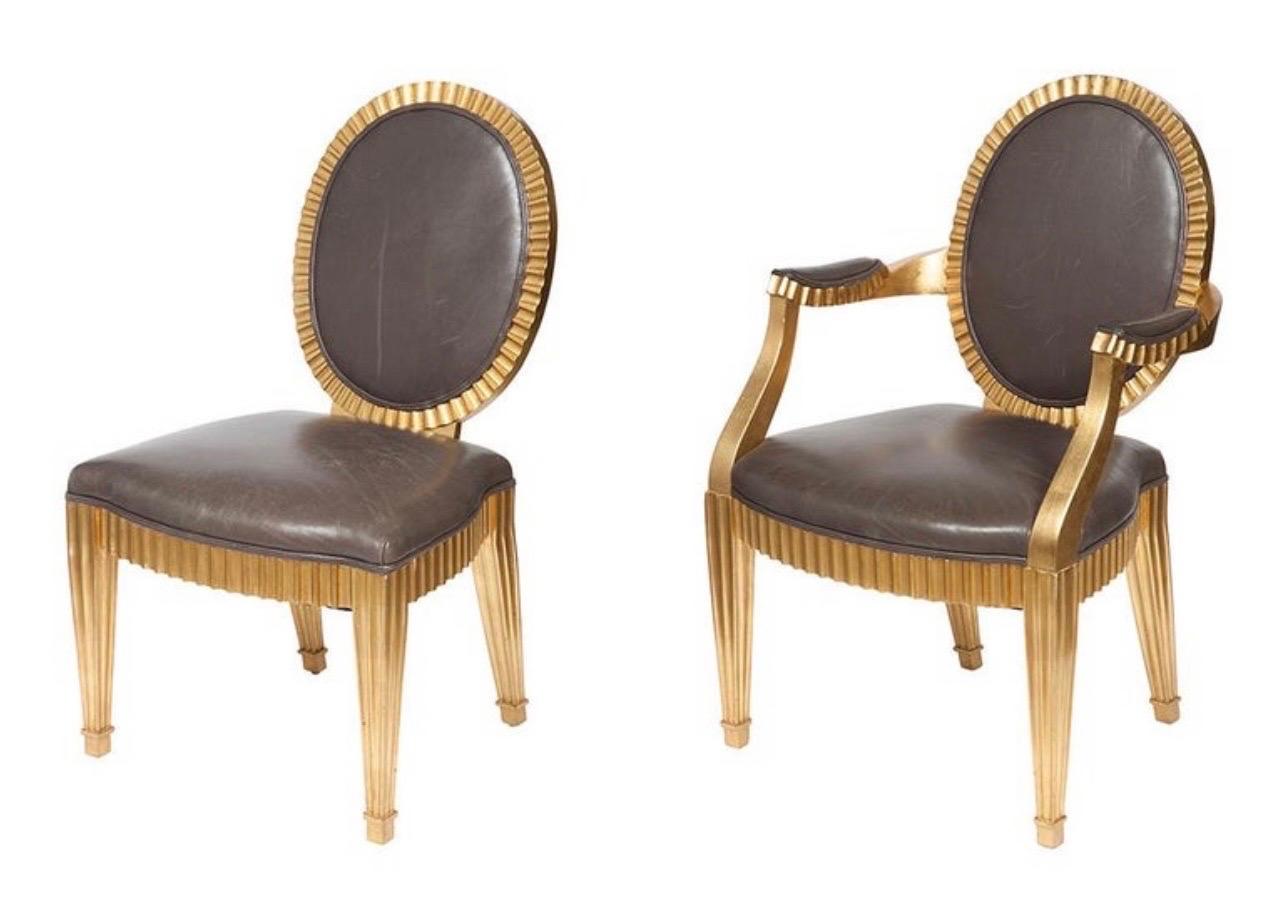 A wonderful set of ten John Hutton for Donghia grey leather upholstered oval back giltwood fluted grand Soleil dining chairs.
Measures: set includes two armchairs: height of armchairs 37 3/4 inches, width 24 3/4 inches, depth 18 1/2 inches, height