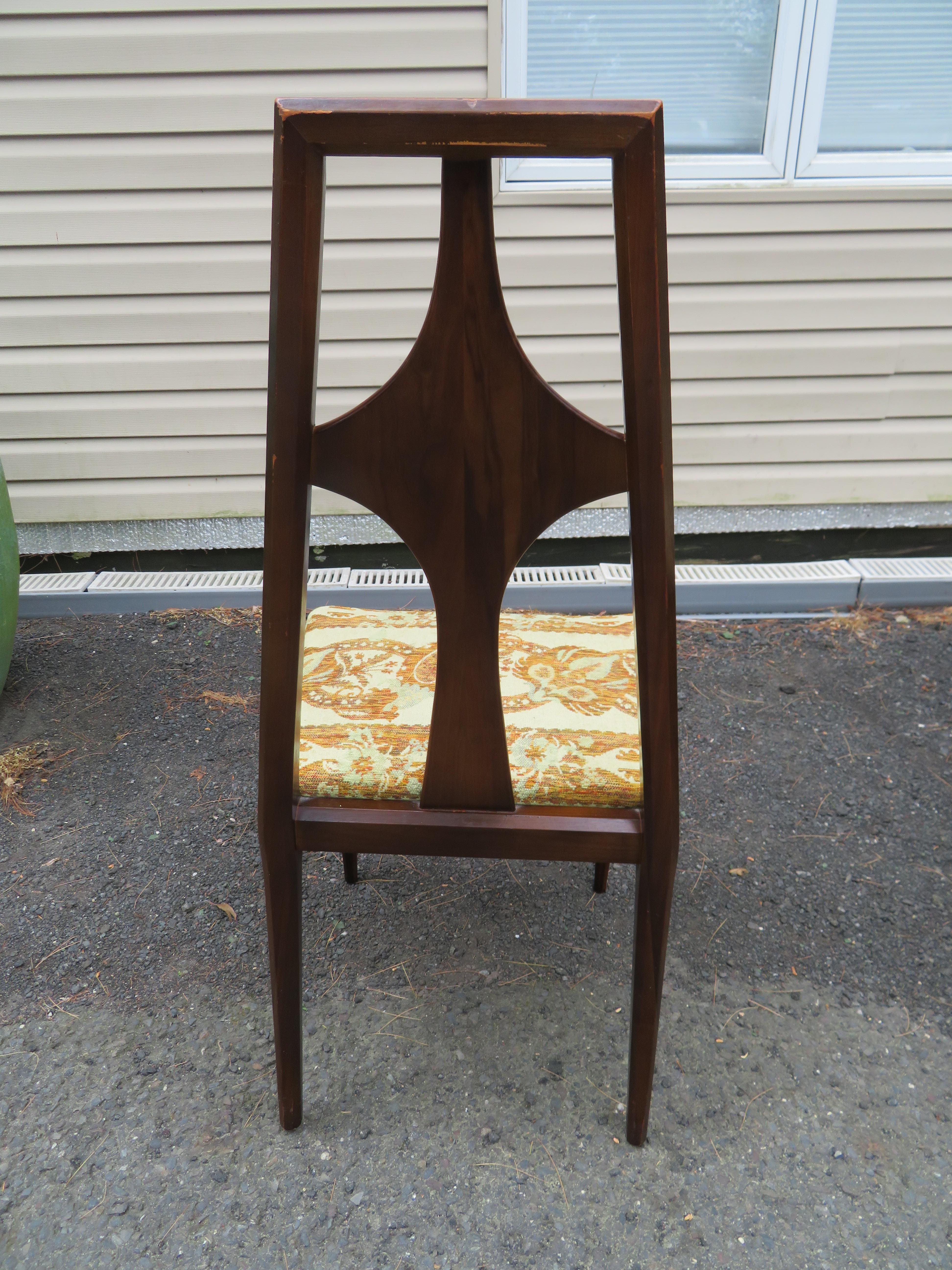 Mid century Swedish modern set of six walnut dining room chairs by Edmund Spence. We love the stylish cross backs along with the faceted legs and arms. The armchairs measure 39.5