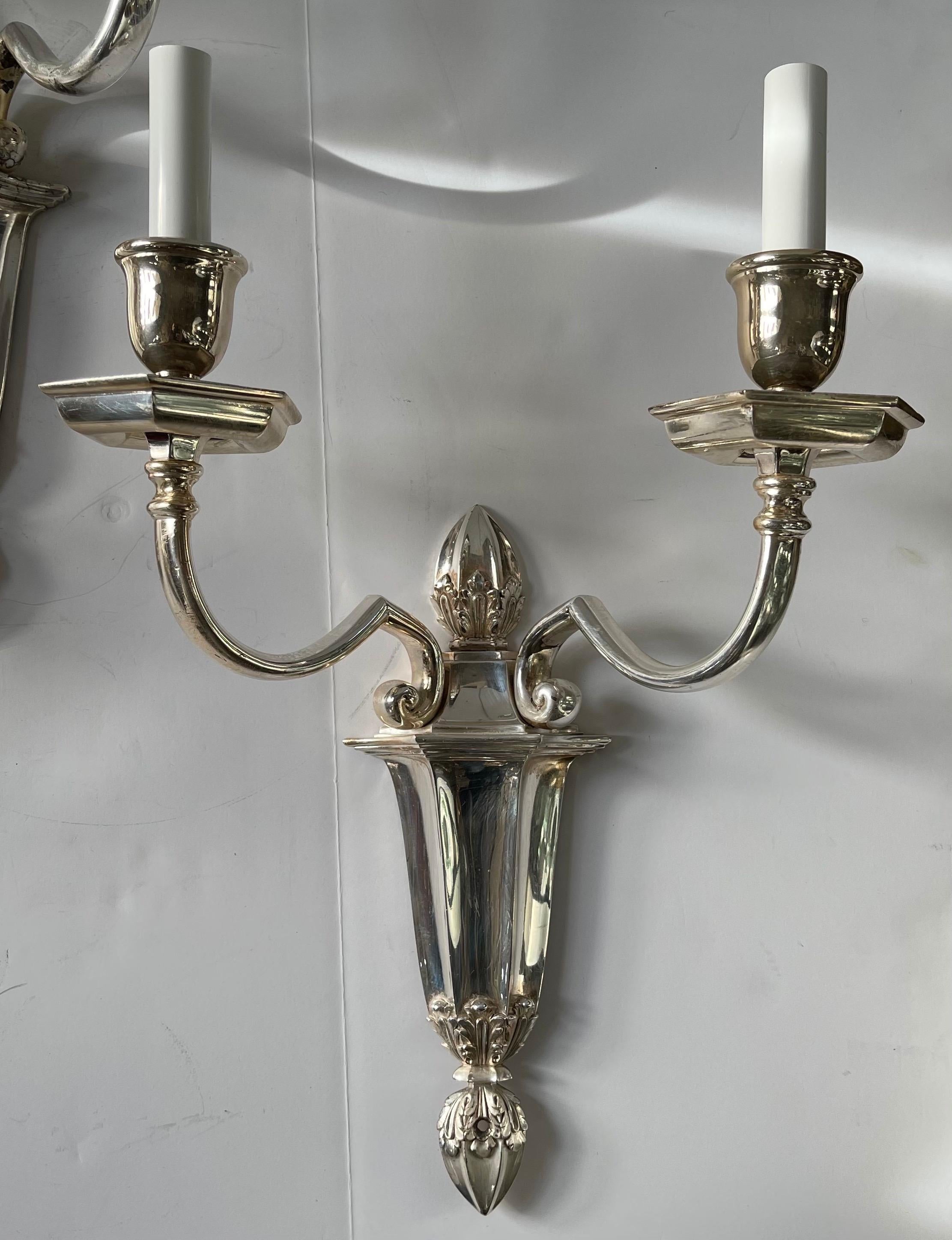 A wonderful pair of stamped E.F. Caldwell silvered bronze neoclassical 2-light sconces

