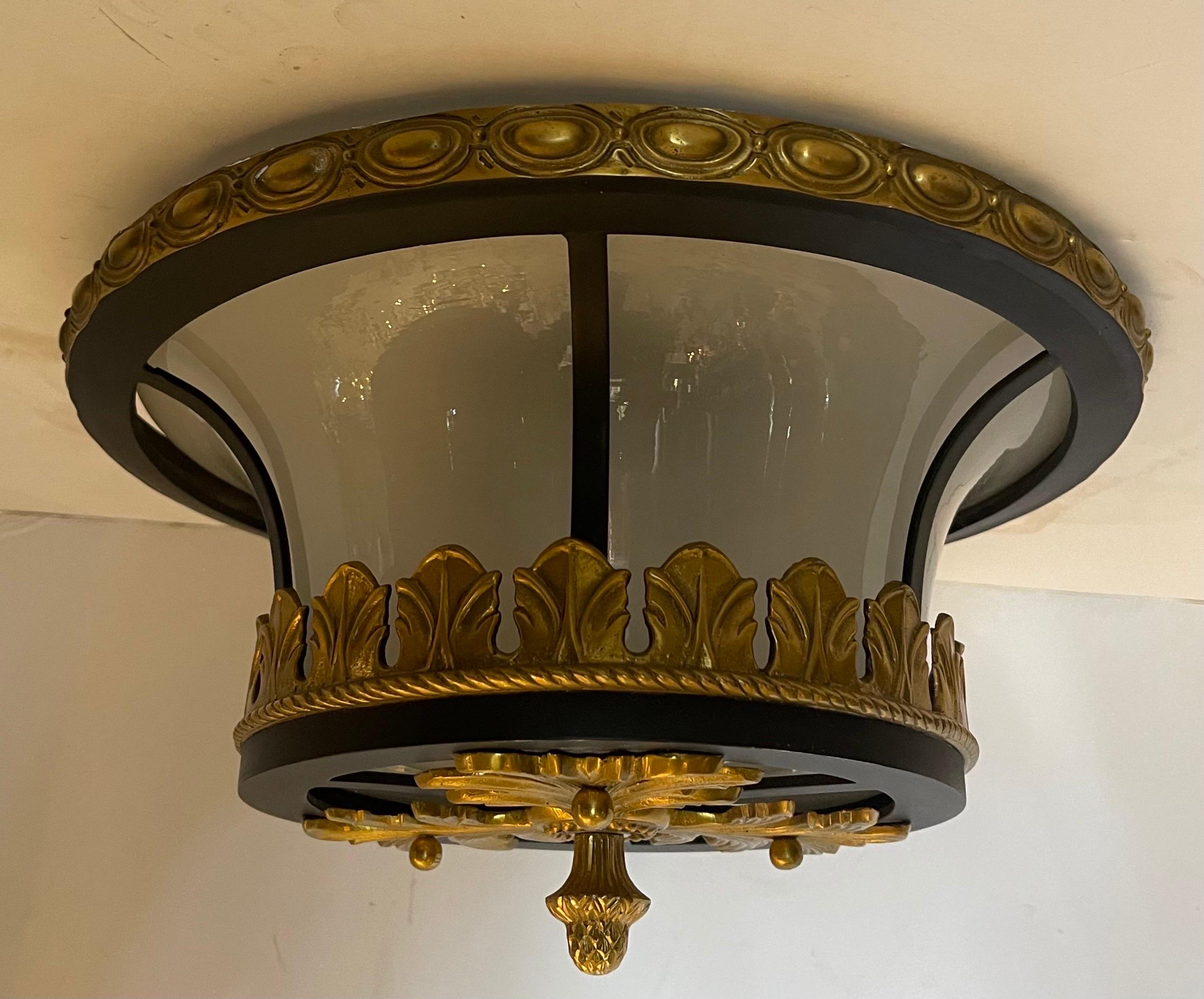 A wonderful French iron with Ormolu bronze mounts inset with a frosted glass light fixtures each with 2 Edison lights inside.


