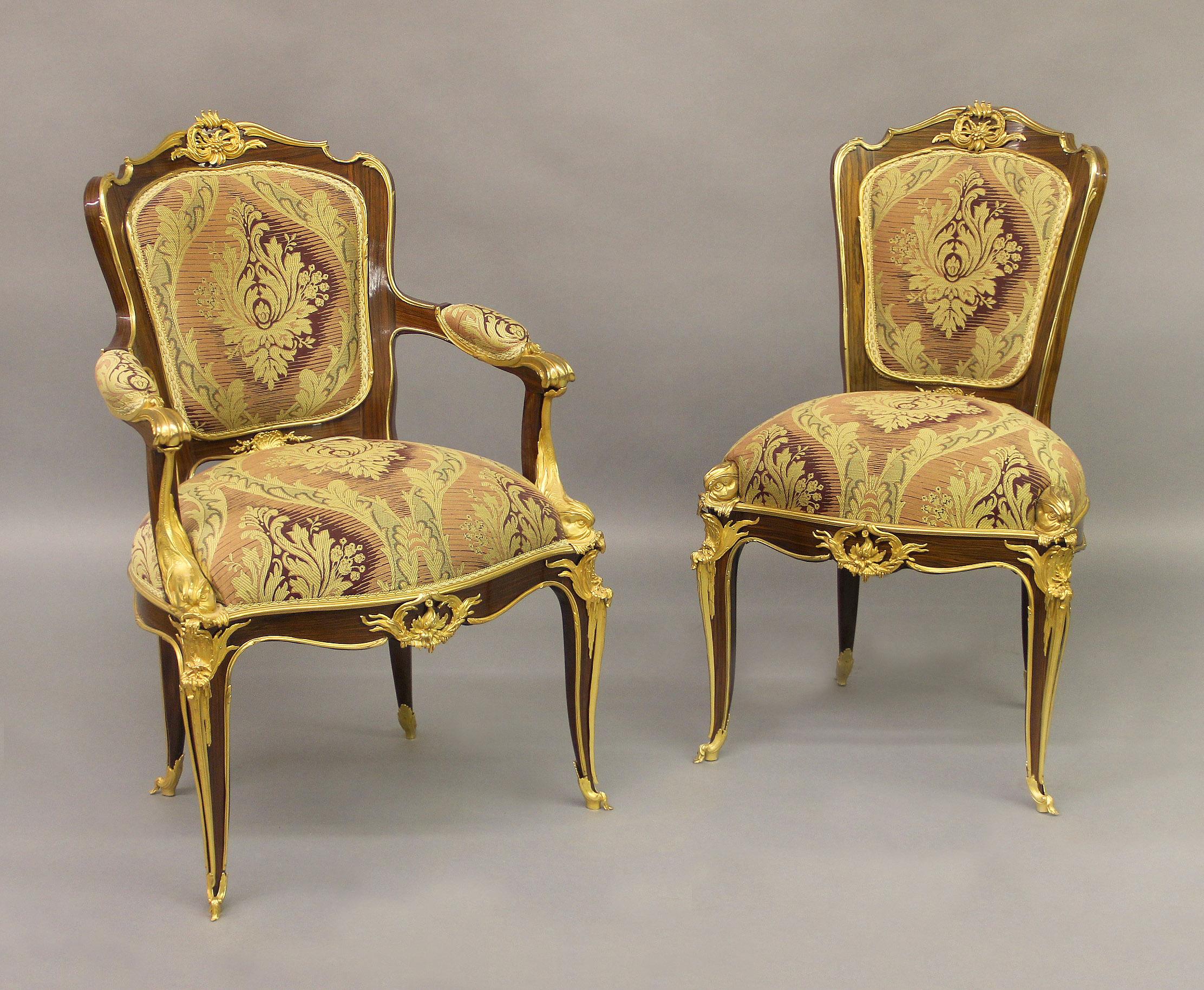A wonderful modern set of eight Louis XV style gilt bronze mounted dining chairs

After François Linke

Comprising of two arm and six side chairs, the shaped backs with a flower cartouche and a shell, armrests flanked by dolphines, the cabriole legs