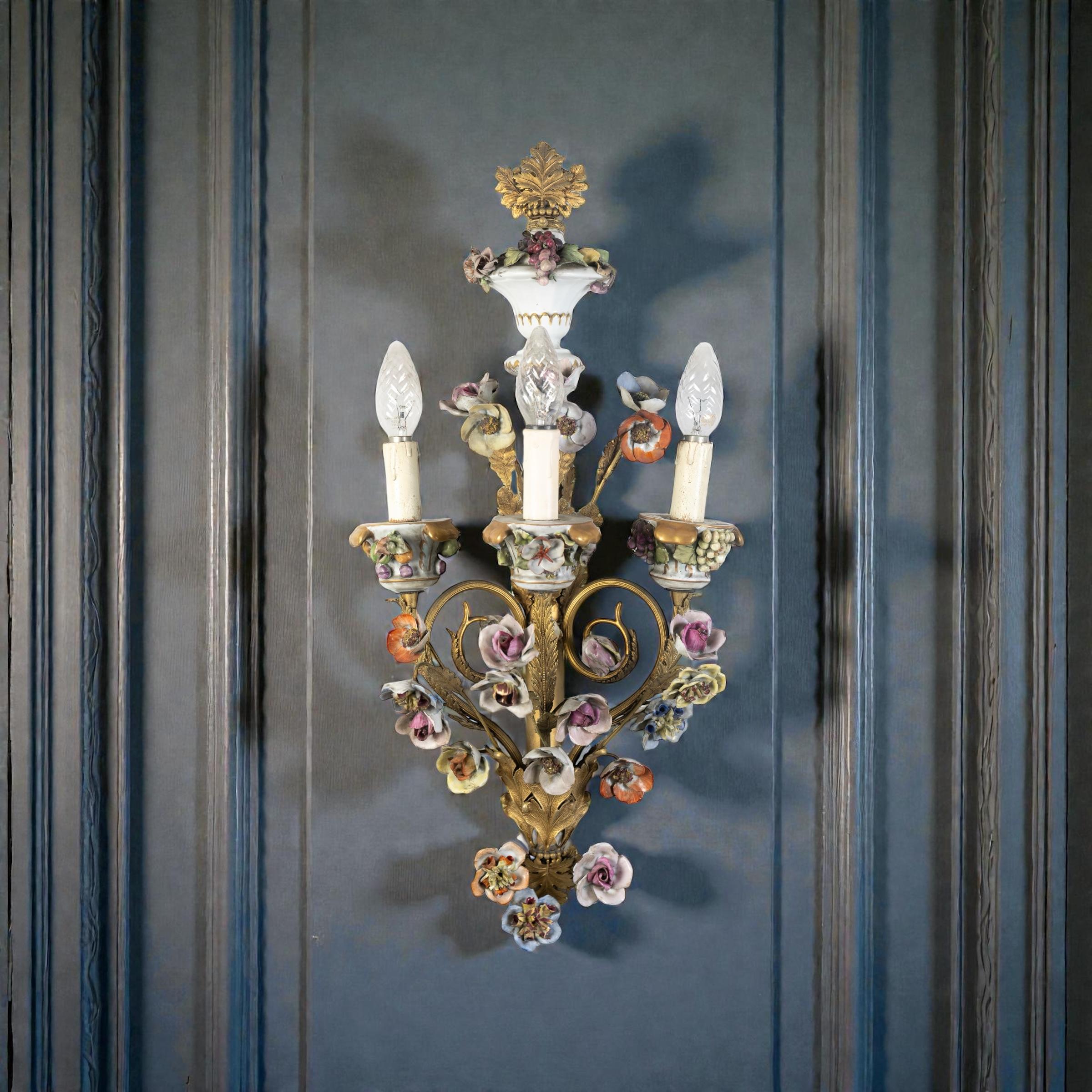 Rare set of four 19th century Wall lights ornamented with colorful porcelain flowers and finely chiseled gilt bronze leaves.
Each with three arms candle holders.
Each with  3 E14 light bulbs, we can rewire for your country standards.
Timeless